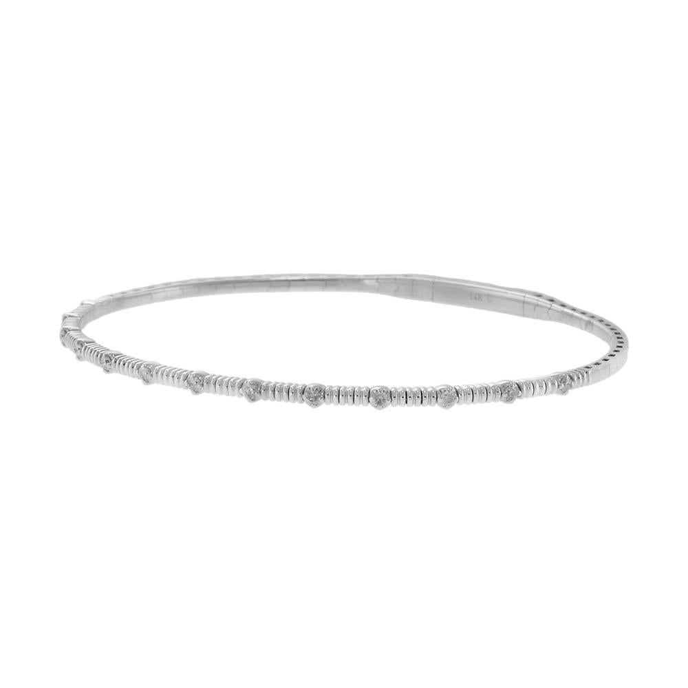 Sleek and refined, this 14KT white gold flex bangle features a delicate pattern of alternating bezel-set round diamonds, offering understated elegance and comfortable wear. With a total diamond weight of 0.20 carats, it’s the perfect touch of