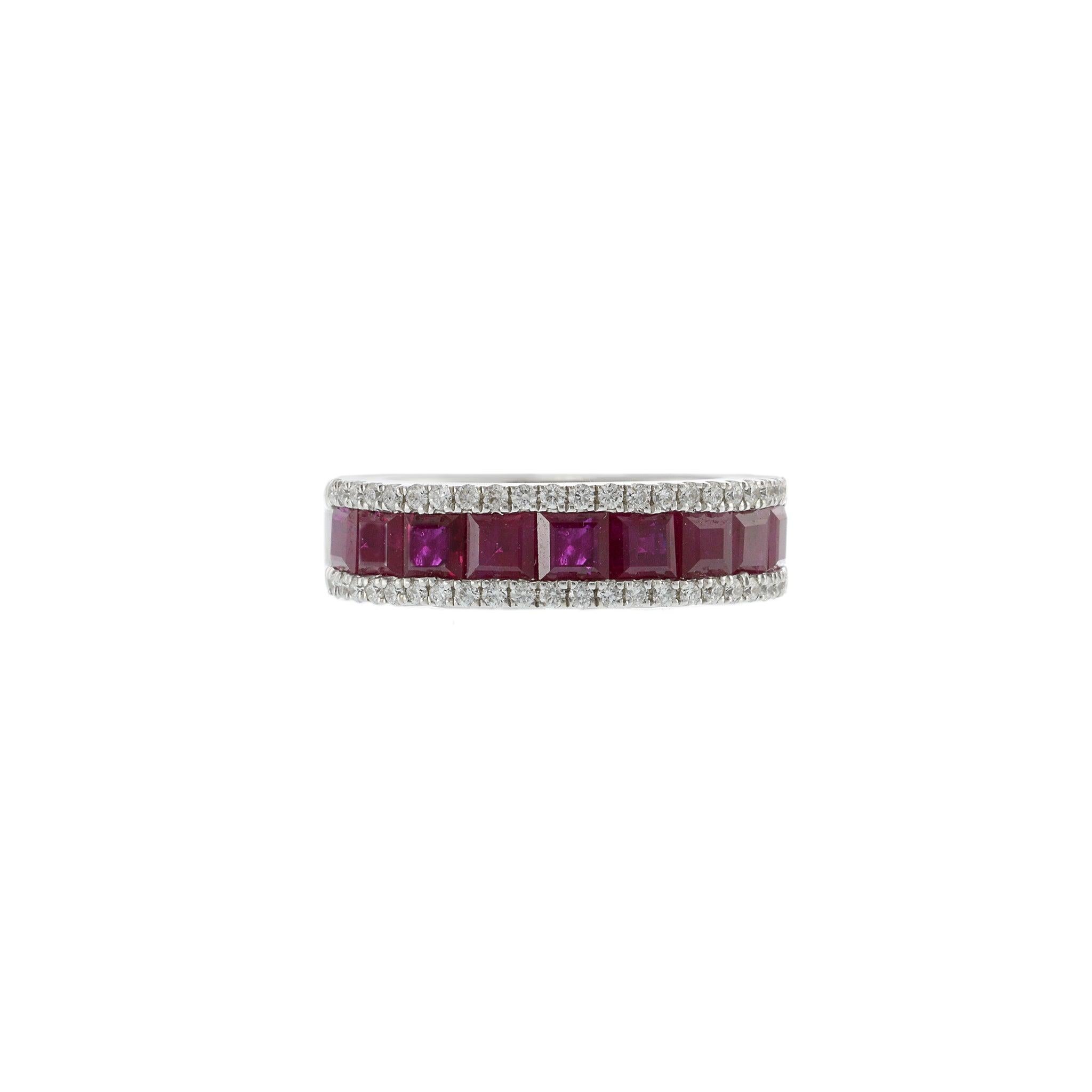 This elegant band features a row of stunning square cut rubies, totaling 2.47 carats, set in the center of 14KT white gold. The vibrant rubies are beautifully complemented by 0.31 carats of round cut diamonds with G-VS clarity on the sides, adding