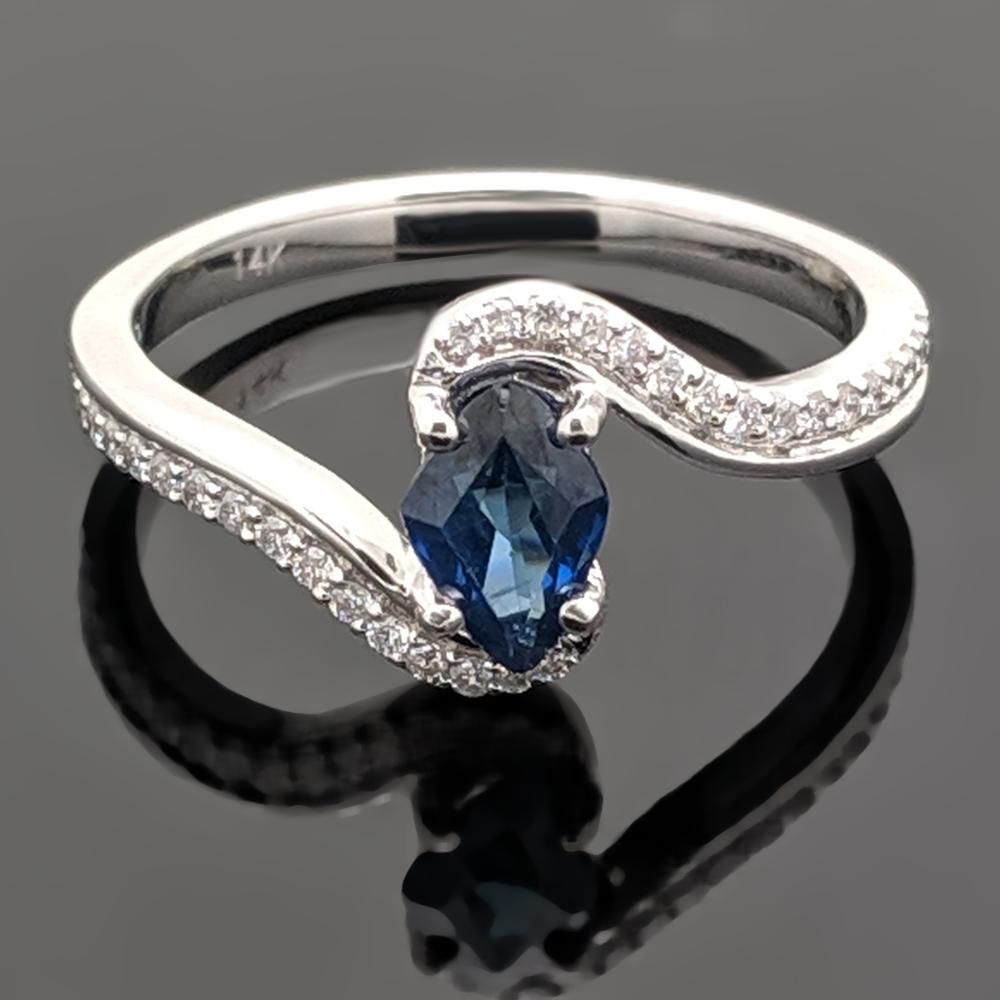 This graceful 14kt white gold ring features a blue sapphire at an estimated weight of 0.62ct with a 4 prong setting and accent diamonds estimated at 0.14cttw. Estimated weight of gold is 2 gr. 

We will size it for you.

