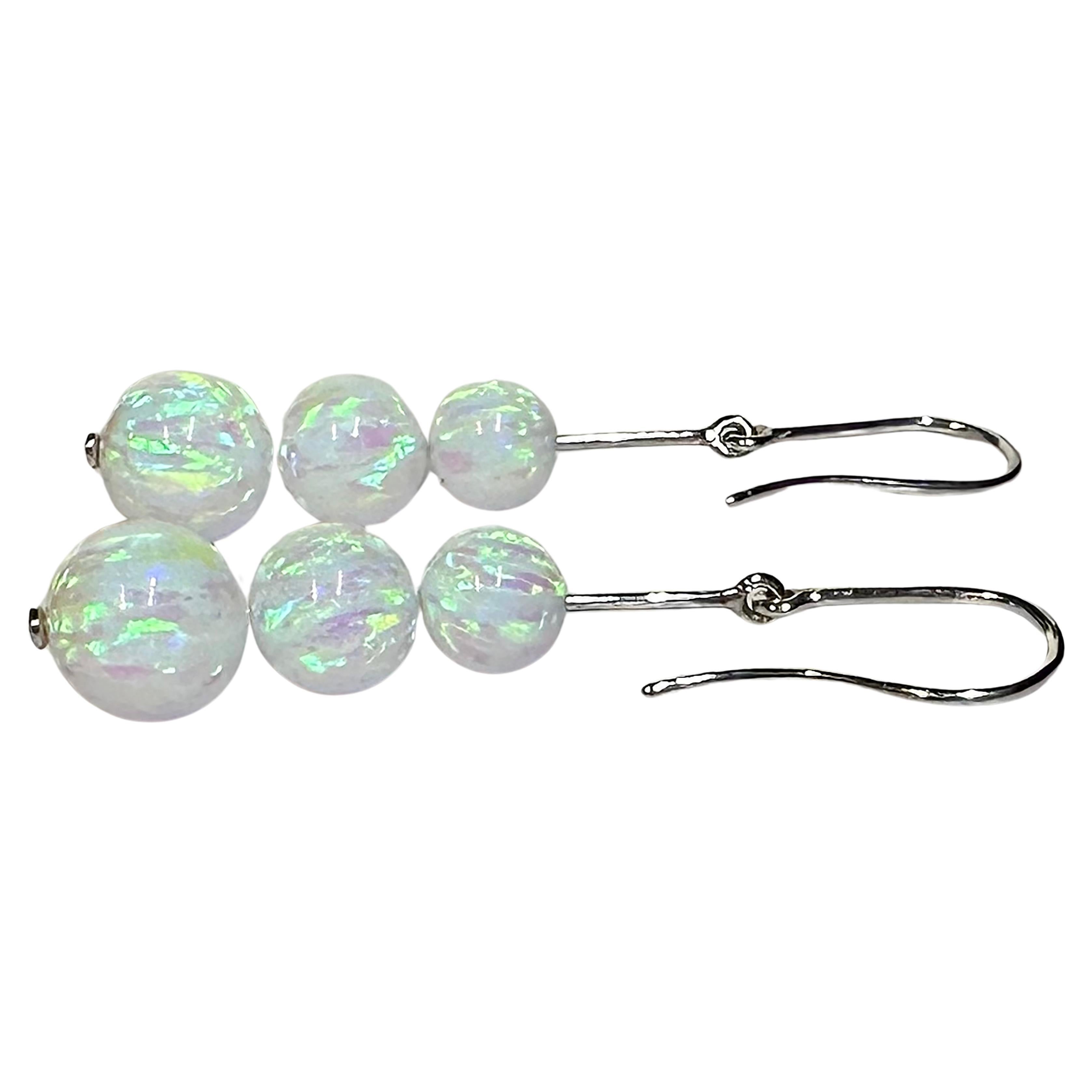 A stunning pair of 14kt White Gold Dangle Earrings set with graduated cultured Opal beads. These spectacular earrings are always in motion when worn and show blues, greens and turquoise colors as they scatter light.

Originally from San Diego,