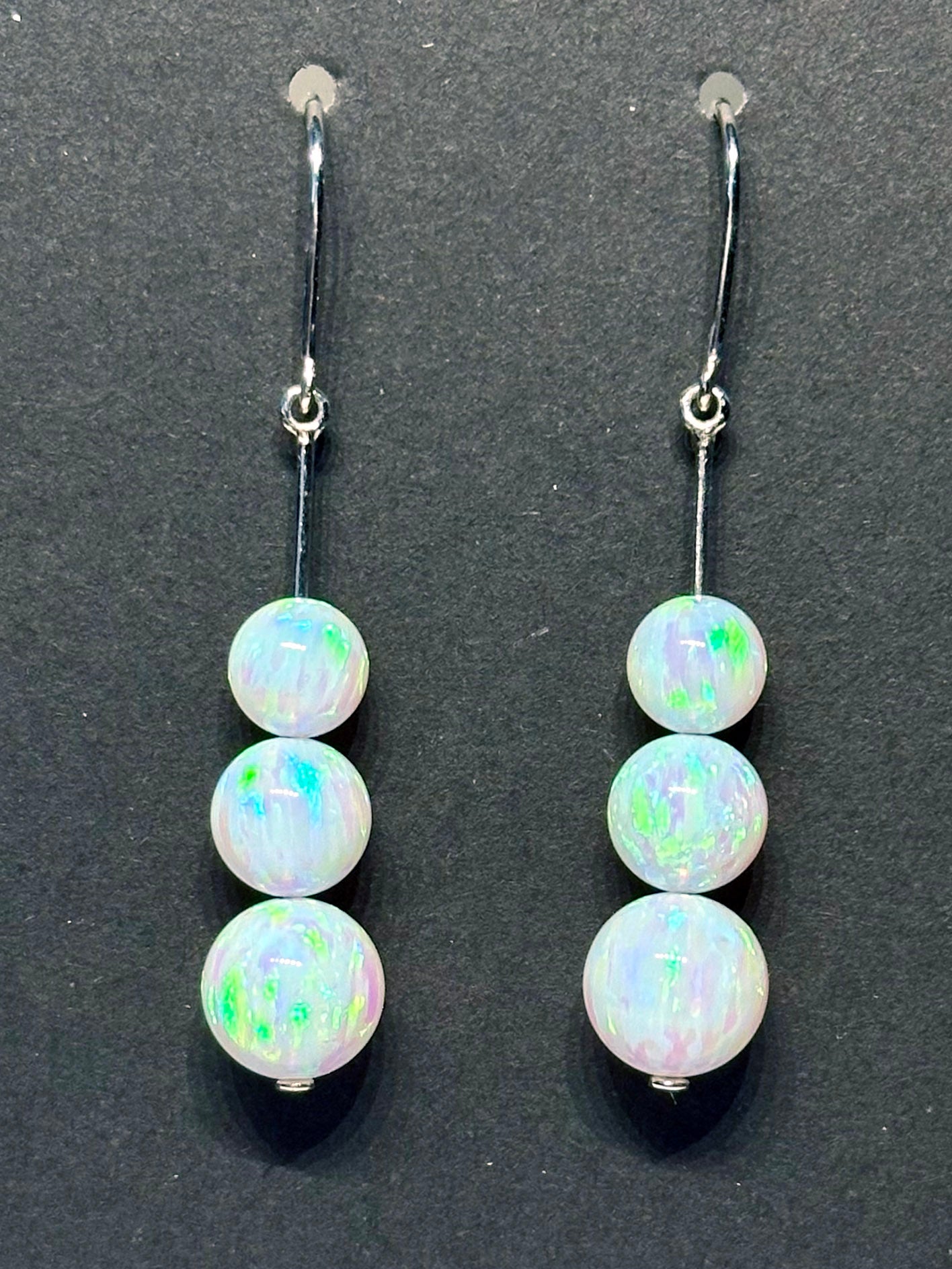 14kt White Gold Dangle Earrings set with cultured Opals