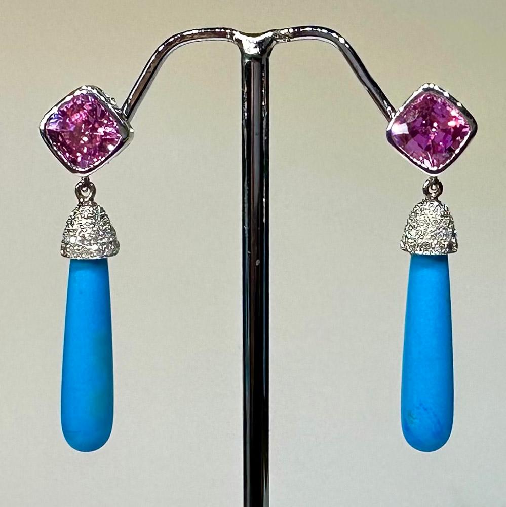 A stunning and colorful pair of 14kt White Gold Dangle Earrings with Pink & White Sapphires and Turquoise Drops. Turquoise are accented by a cap of gold that is set with a pave of white sapphires. 

Originally from San Diego, California, Kary Adam