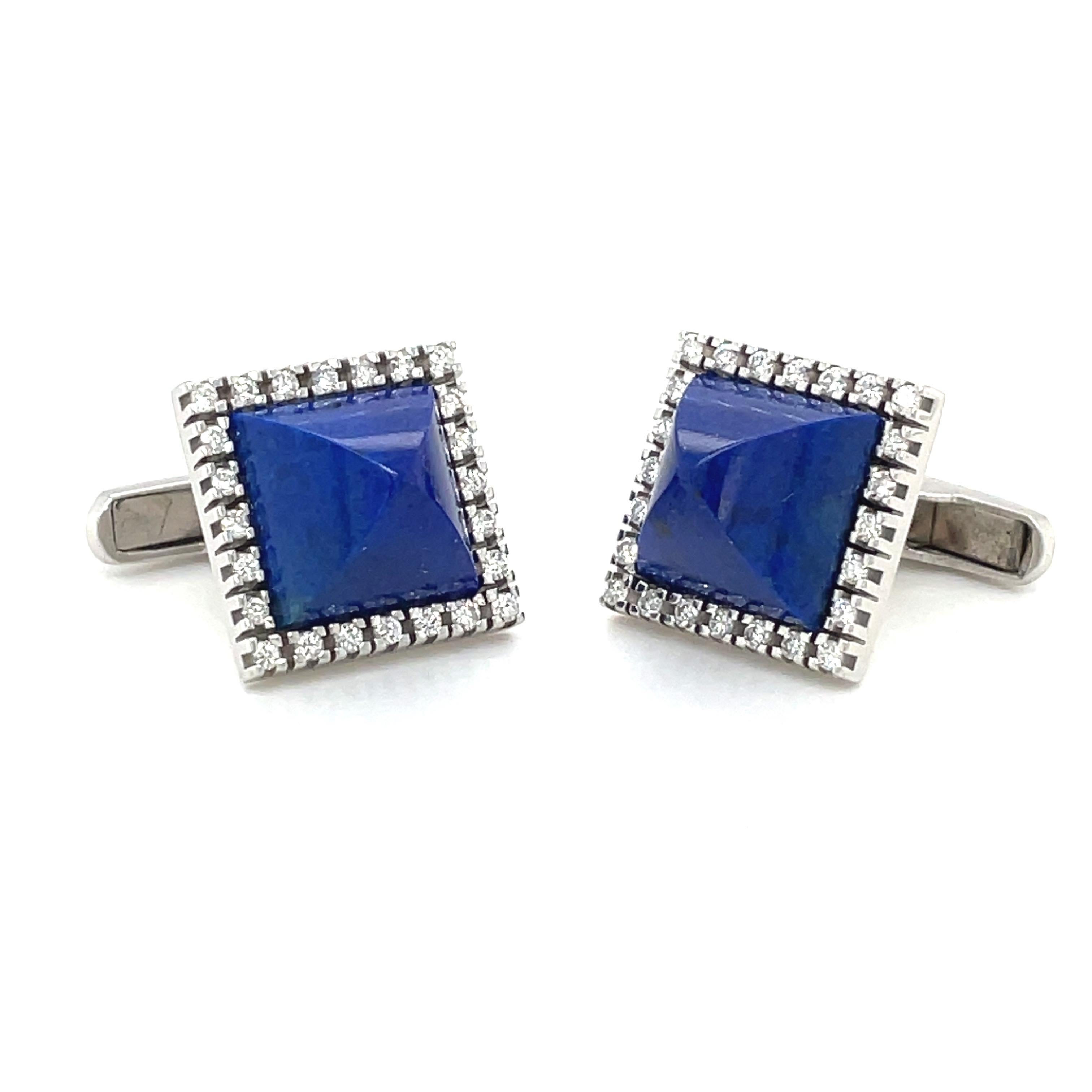 Retro style gorgeous 14 karat white gold square cuff links. The cuff links center large sugar loaf cut lapis lazuli stones with a border of round diamonds, 0.96 carats. They measure 17.3 mm and are the bar style.
Stamped AB 14K