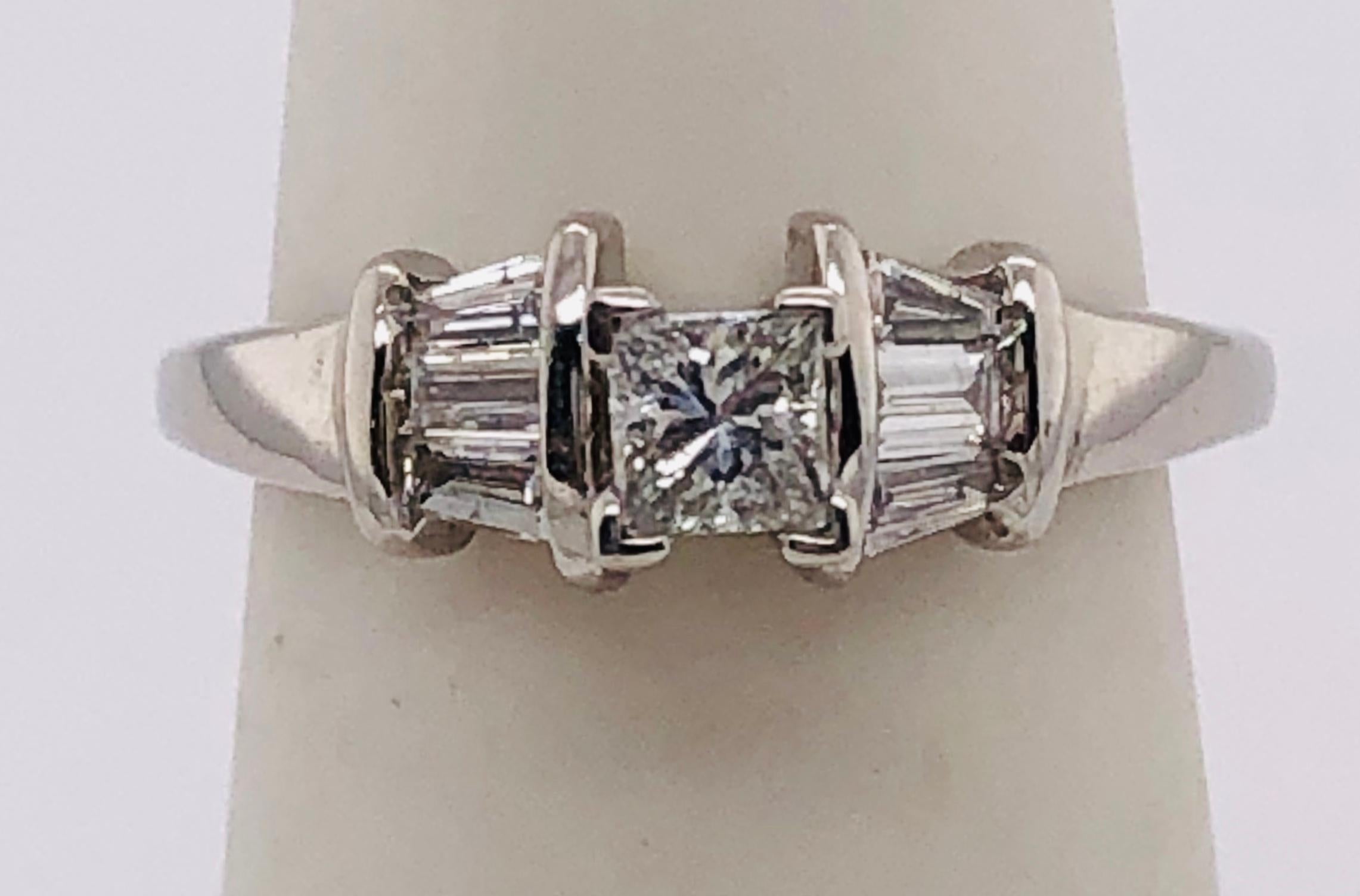 14Kt White Gold Engagement Ring Princess cut Center Diamond Side Baguette Cut Diamonds
Apprx 0.9 Total Diamond Weight, Main stone 0.3 carat.
Size 5.75 
5.20 grams total weight.
