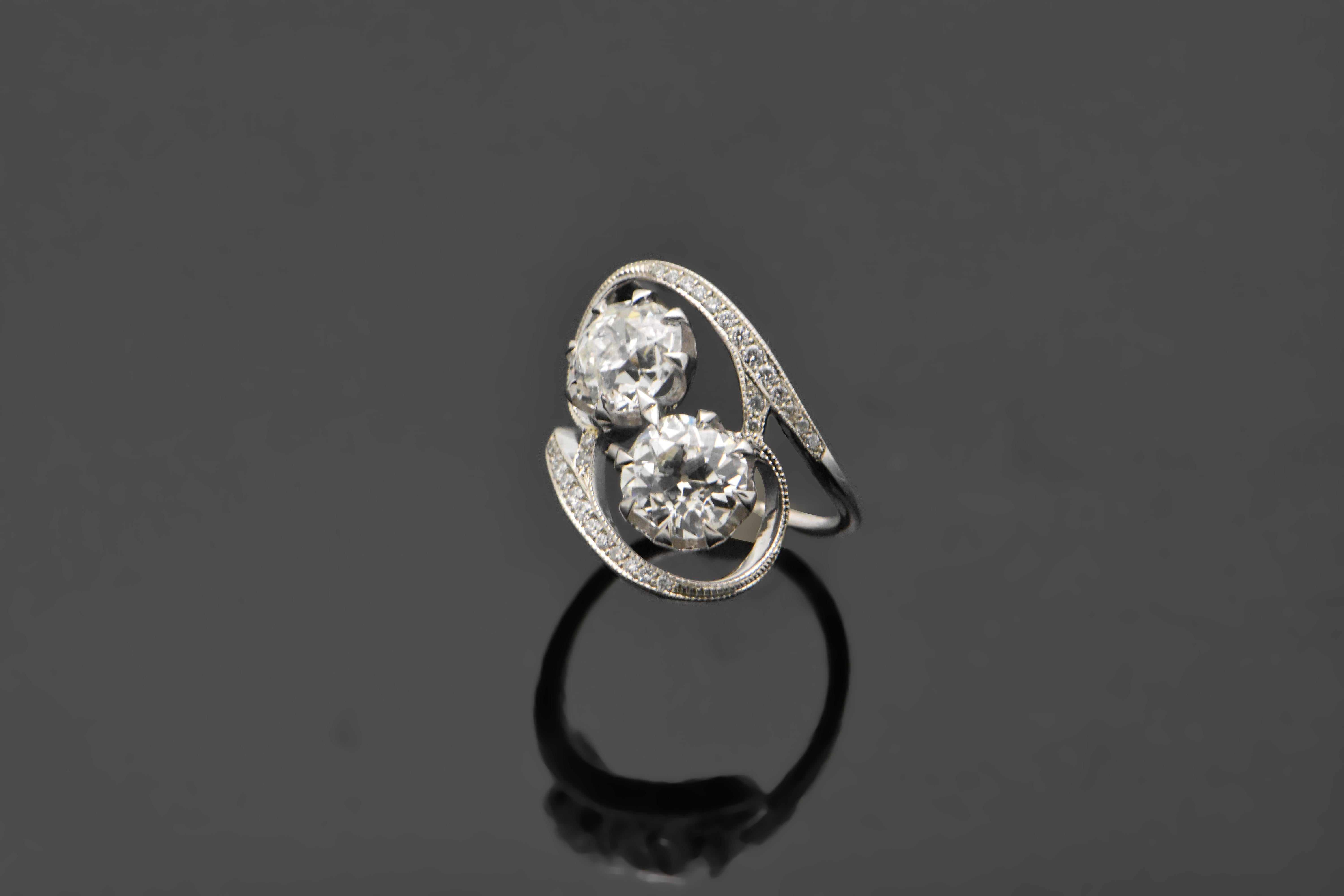 14kt White Gold Diamonds. This design features two large diamonds each set in 8 prongs surrounded by swooping  white gold band details lined with diamonds.

This item is a custom order only. Price is for the ring setting only. The stones will be