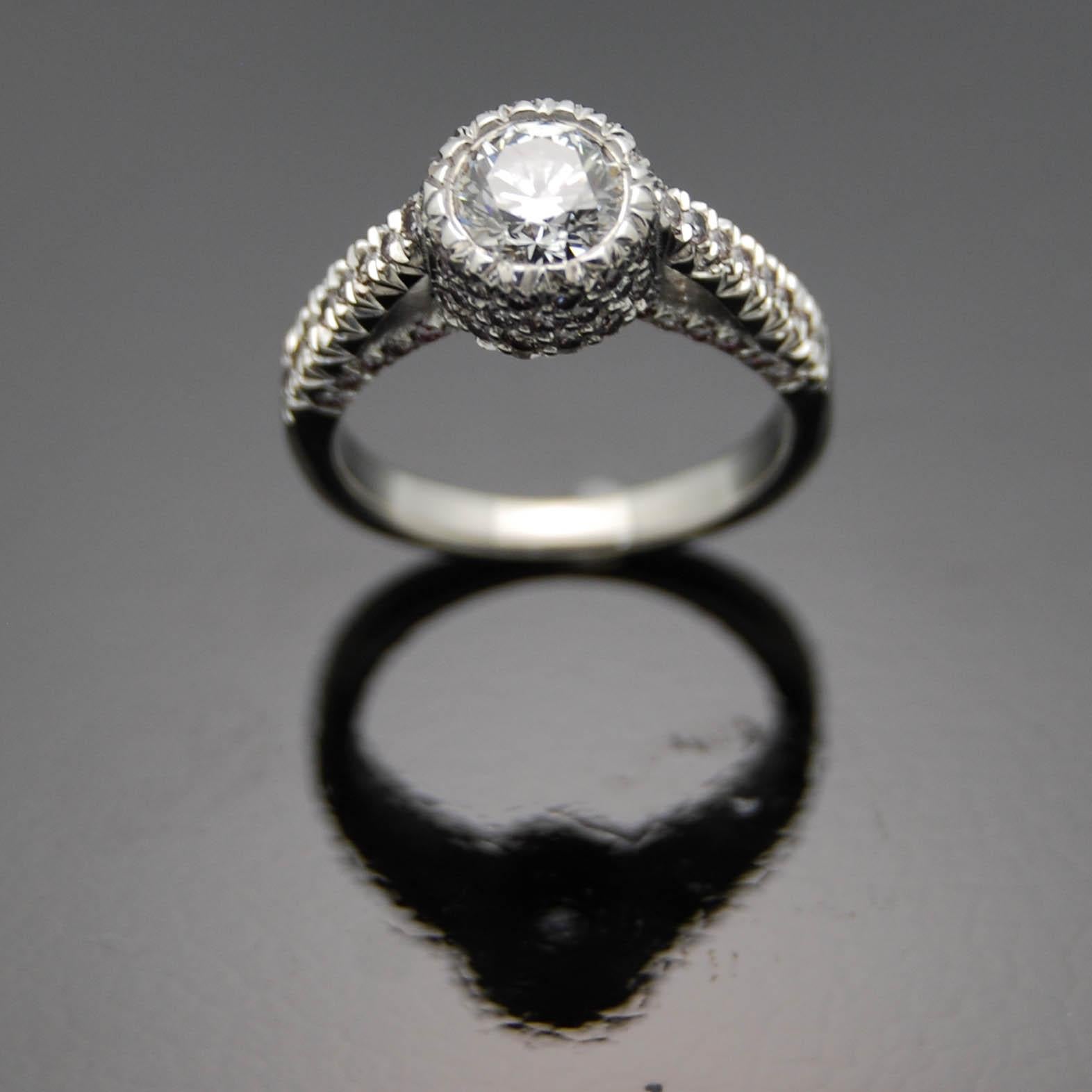 14kt White Gold Diamonds Ring. This design features a bezel set brilliant cut diamond with fine details, a raised setting and pink accent diamonds underneath.

This item is a custom order only. Price is for the ring setting only. The stone will be