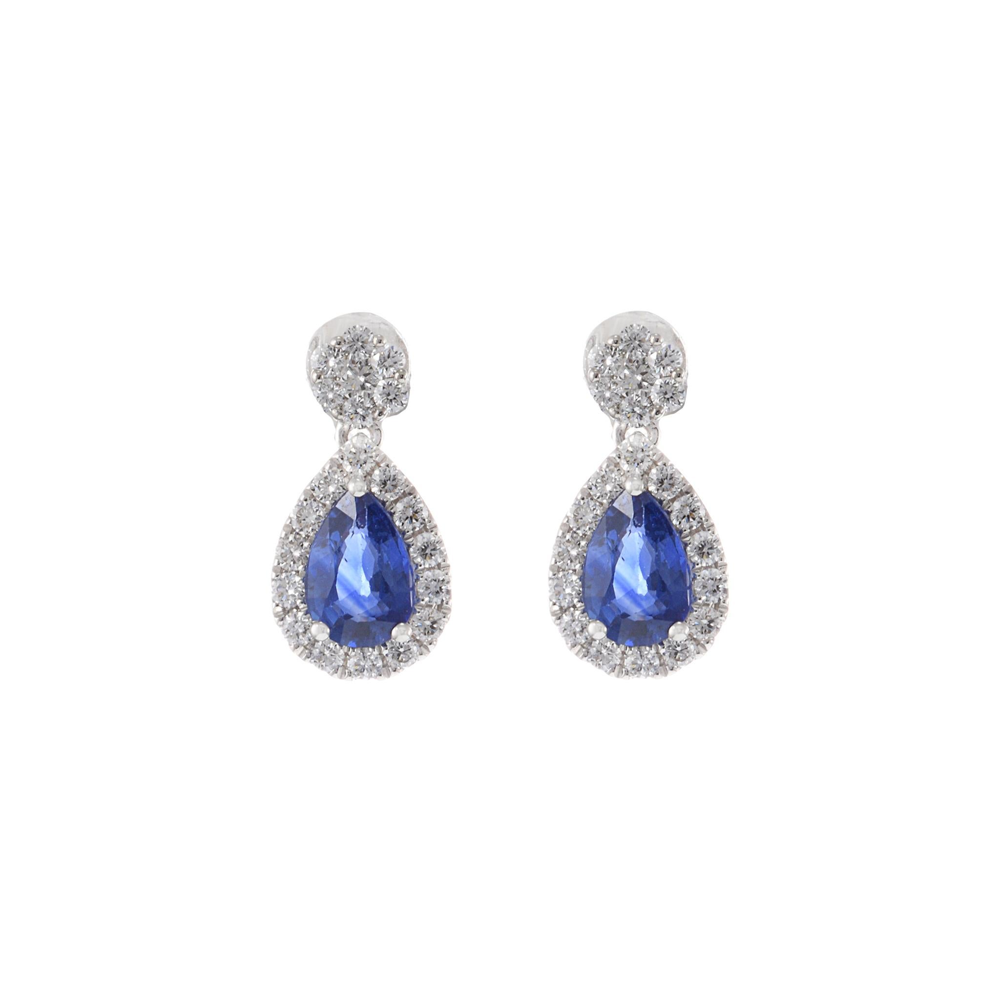 14KT White Gold Drop Earrings with Round Cut Diamonds and Pear Cut Sapphires. These stunning earrings feature 0.42 carats total weight of G-VS round cut diamonds and 1.09 carats total weight of pear cut sapphires. Crafted from 14KT white gold, the