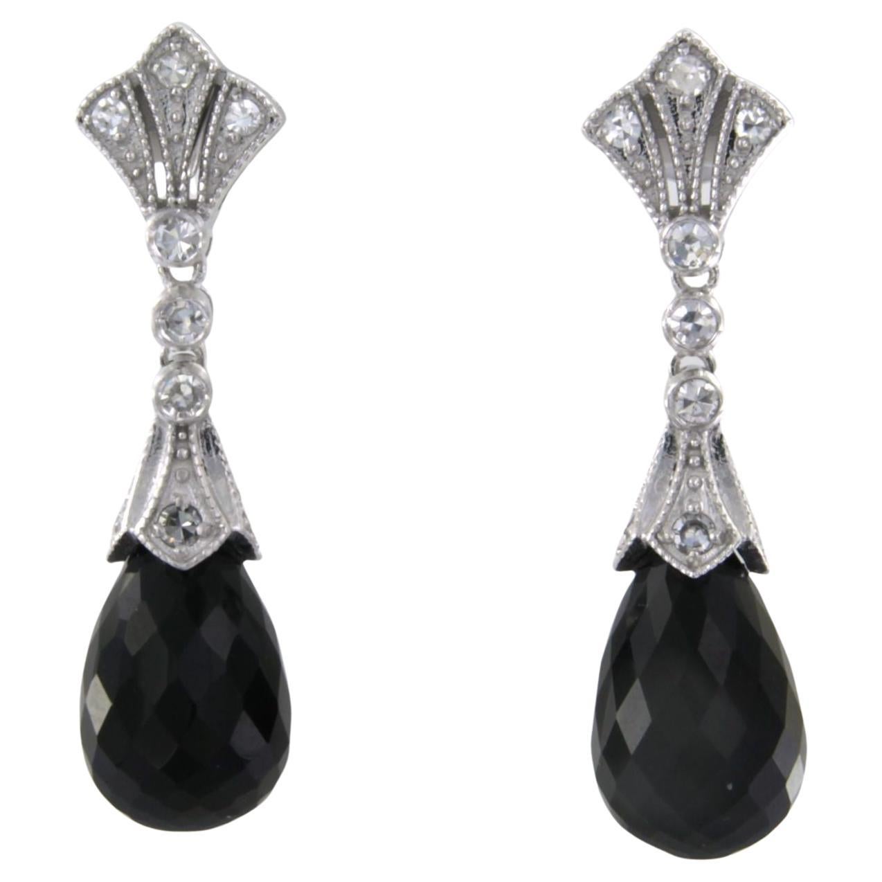 14kt white gold earrings set with onyx and single cut diamond total 0.34ct