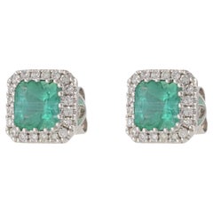14KT White Gold Emerald and Diamond Halo Earrings