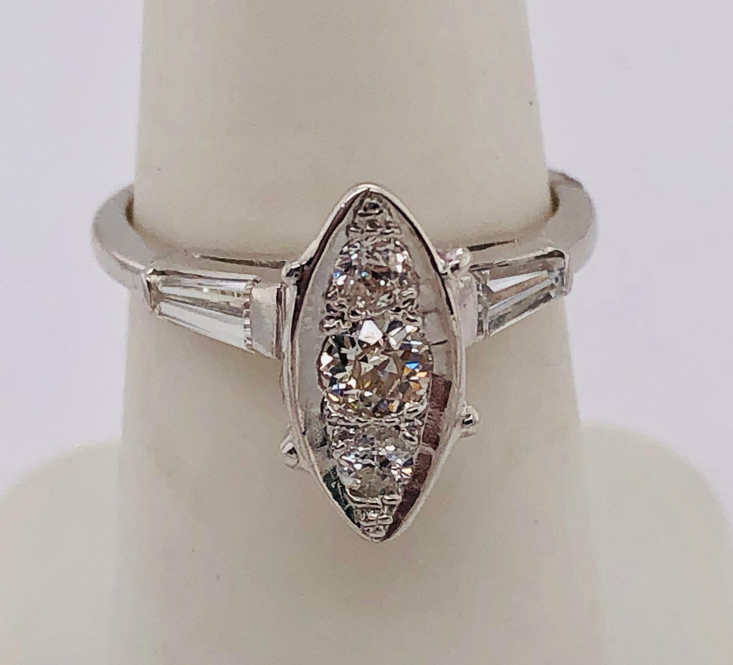 14Kt White Gold Engagement Ring with Round and Baguette Cut Diamonds 1.00 Total Diamond weight
Size 6.5 with 4.48 grams Total weight.