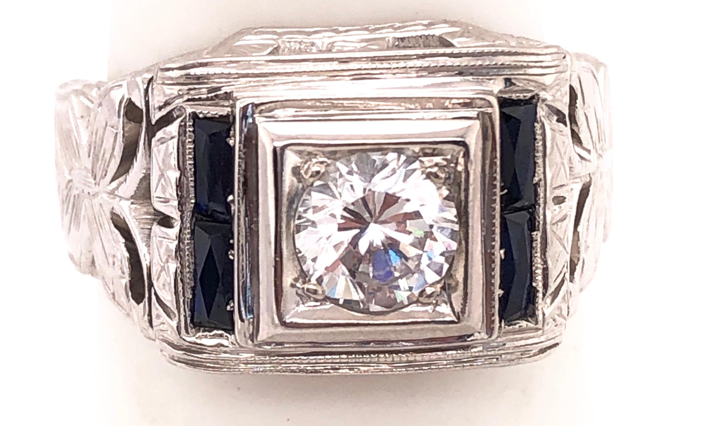 14KT White Gold Fashion Ring with .70 Round Diamond and 4 Sapphires.
Size 7. 8.60 grams total weight.