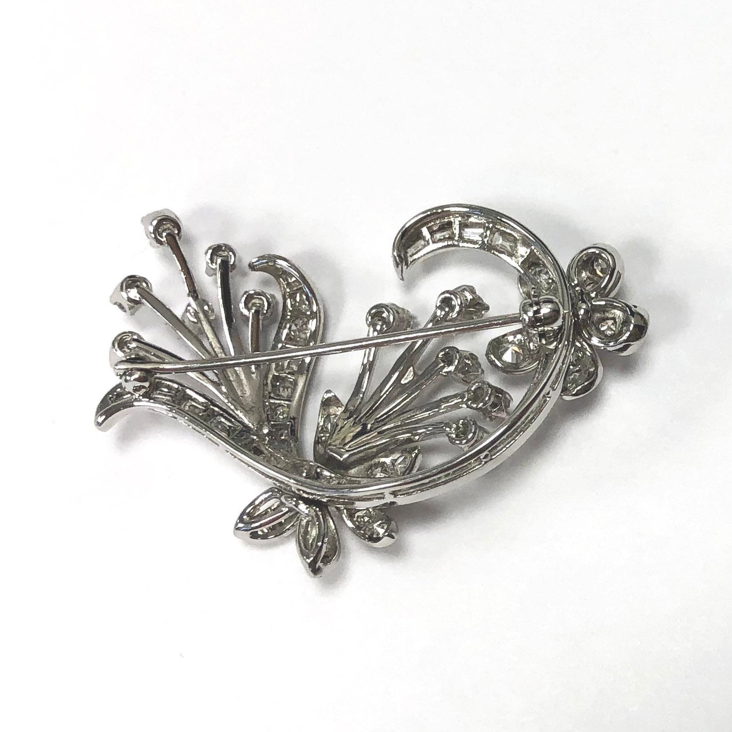 14Kt White Gold Flower Bouquet Brooch with Single Cut and Baguette Diamonds with a safety ''C'' clasp. 

- 29 Single Cut Diamonds = approx. 0.51 Ct total weight
Clarity SI, Color H

- 14 straight baguette diamonds = approx. 0.28 Ct total