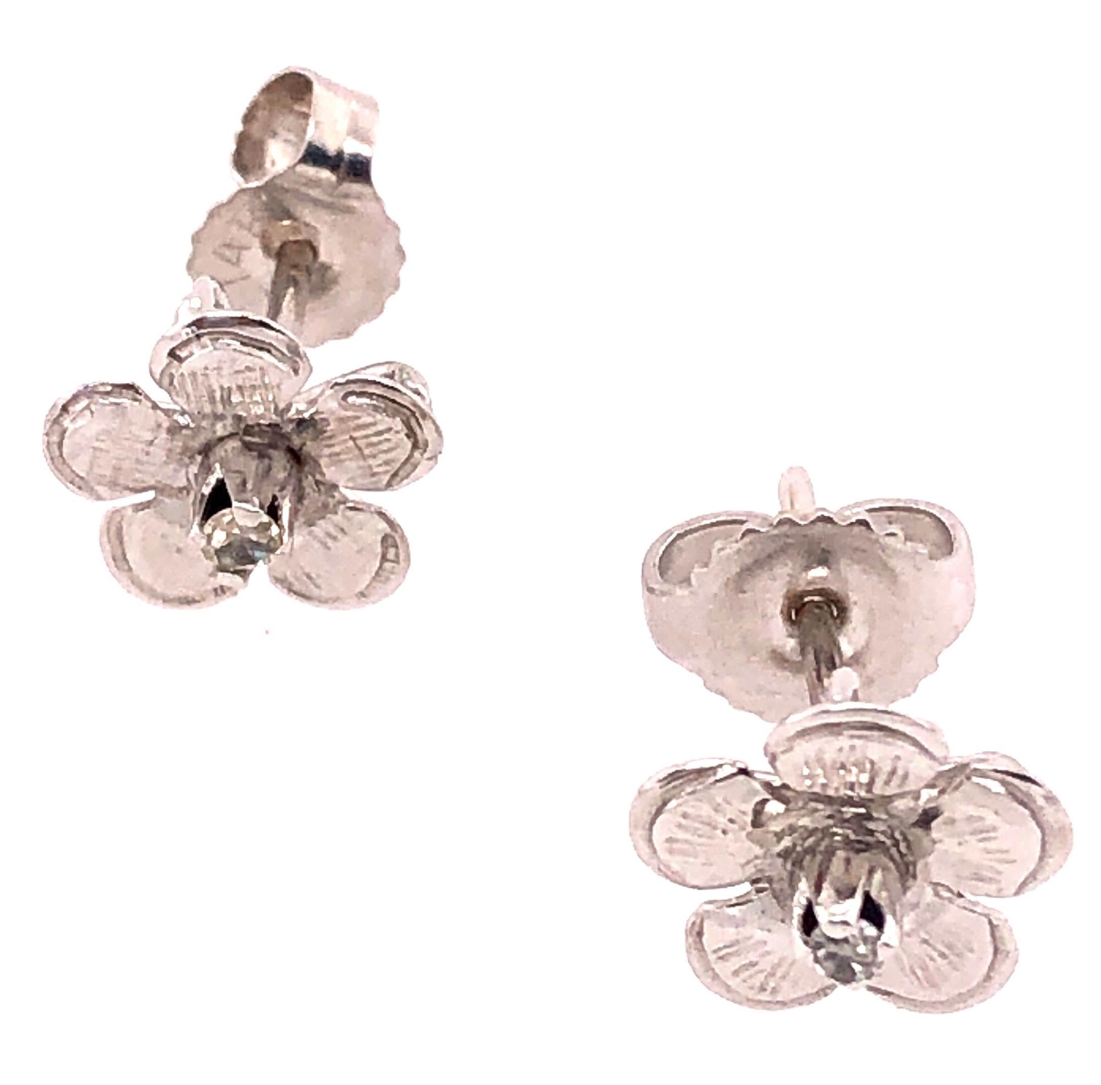 14Kt White Gold Flower Stud Earrings with Round Diamond  1.17 grams total weight. 2=0.10tw Round Diamond

