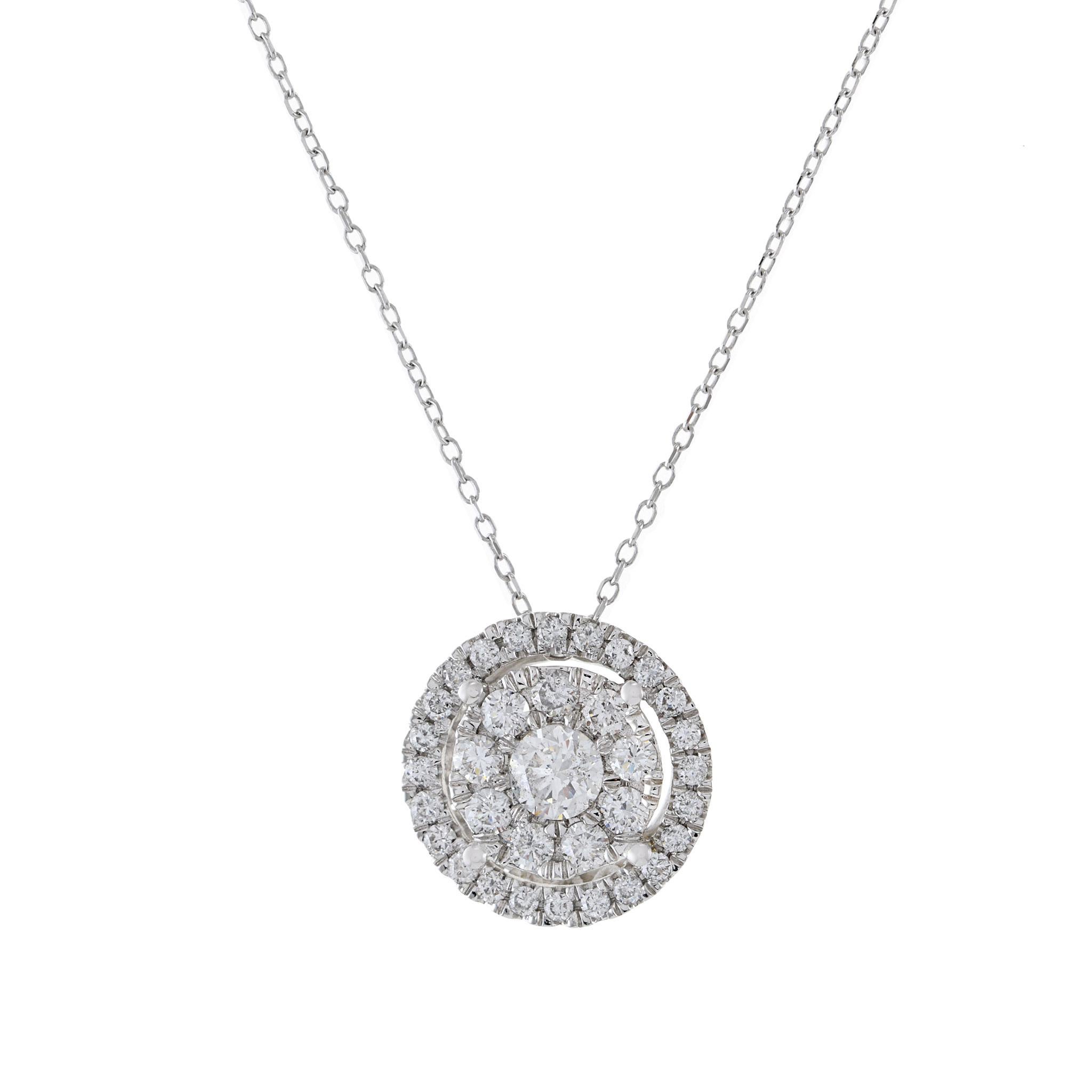 14kt White Gold Round Halo Cluster Diamond Pendant Necklace. This exquisite piece features a central halo of 0.75ct-tw G-VS/SI round-cut diamonds, creating a captivating and sparkling cluster. Suspended from a 14kt white gold chain, this necklace