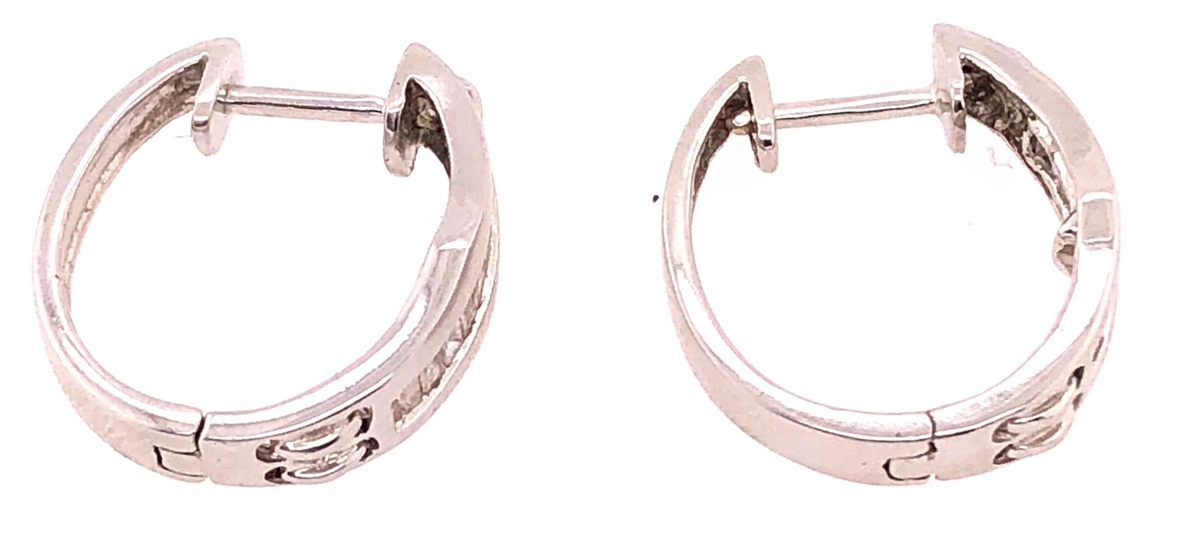 14Kt White Gold Hoop Freestyle Earrings 2.87 grams.

Lia