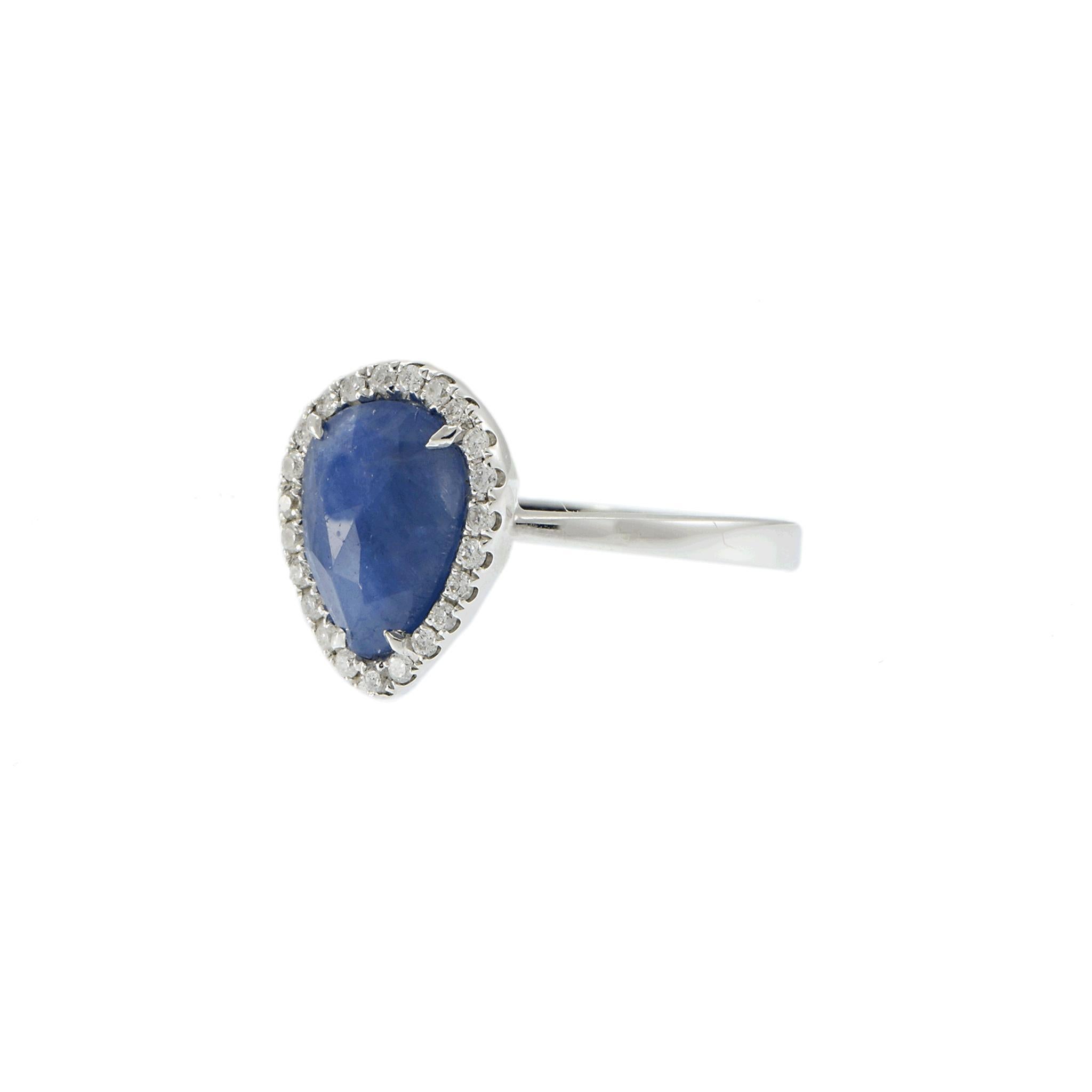 Elegant and timeless, this 14KT white gold ring showcases a captivating 2.09-carat pear-shaped sapphire, certified by GAL for authenticity and quality. The vibrant sapphire is framed by a shimmering halo of round brilliant-cut diamonds, adding a