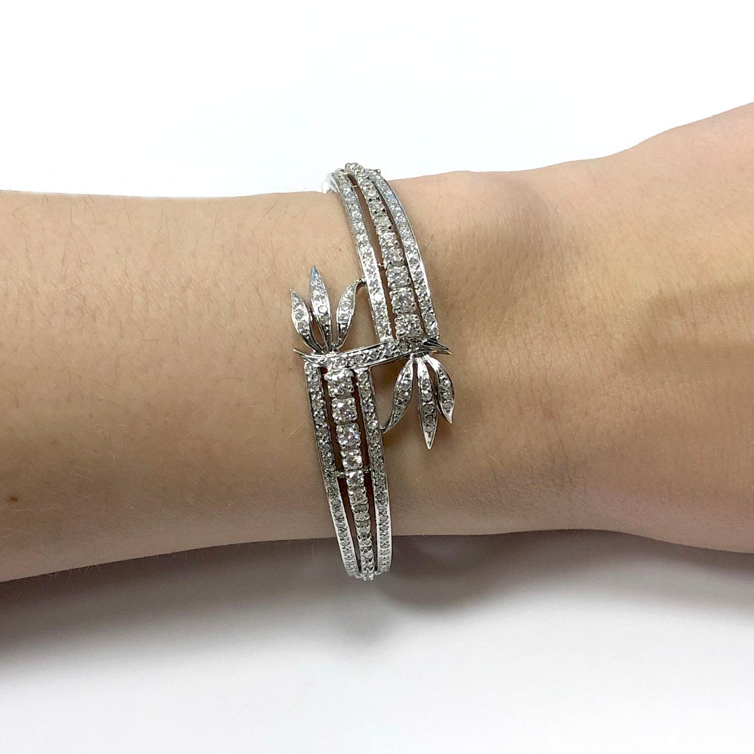 14Kt White Gold Rigid Bypass Lady's Bracelet with estimated 1.83ct of diamonds with push clasp and a safety eight clasp.

- 10 graduated round brilliant cut diamonds = approx. 0.56 Ct total weight
- 17 graduated single cut diamonds = approx. 0.18 Ct