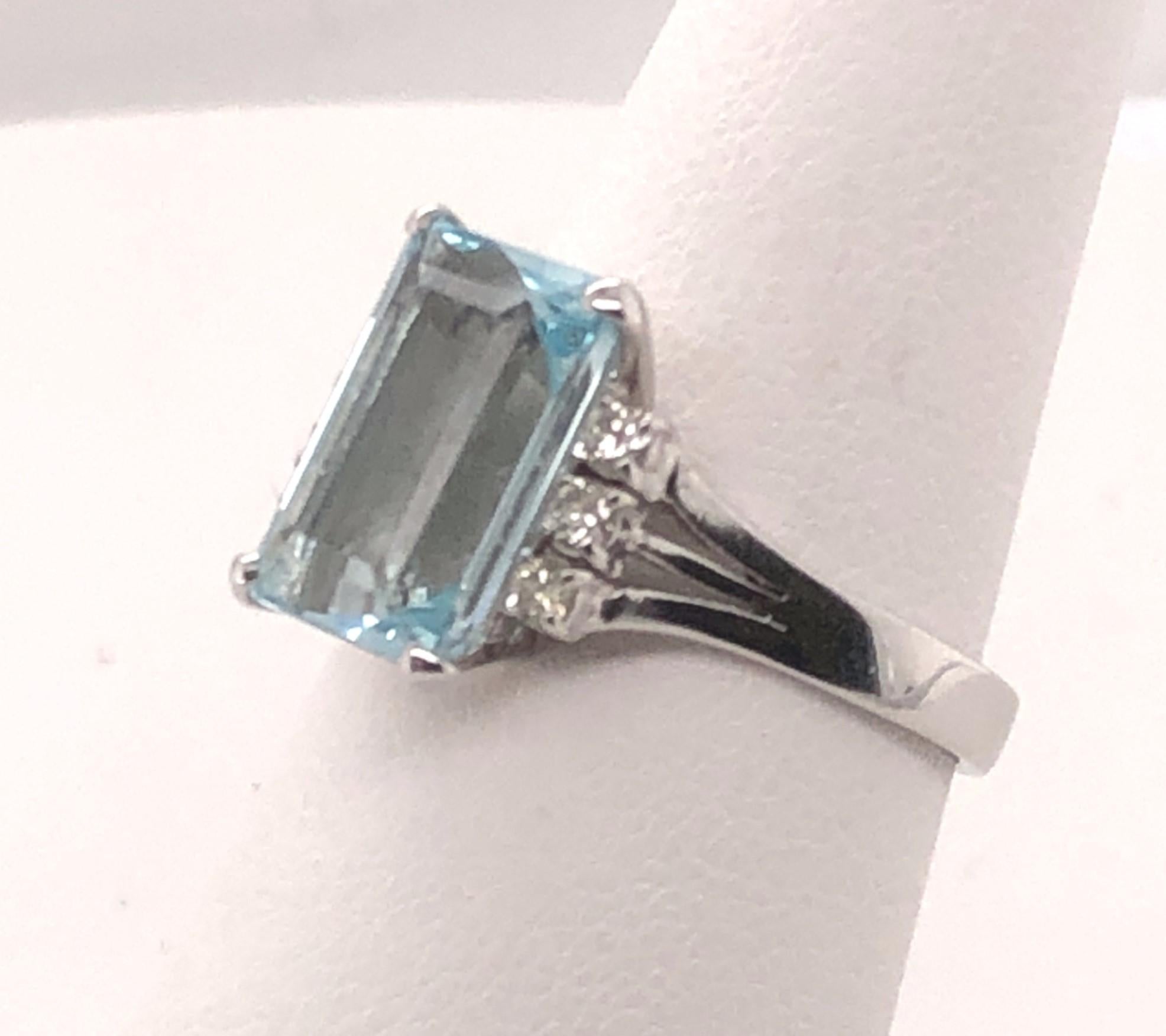 This ring is a classic and will never go out of style! The 14kt white gold ring contains one prong set center 3.04 carat rectangular cut Aquamarine with .12 total carats of H color SI1-SI2 diamonds on the sides. This ring is a finger size 7 and can