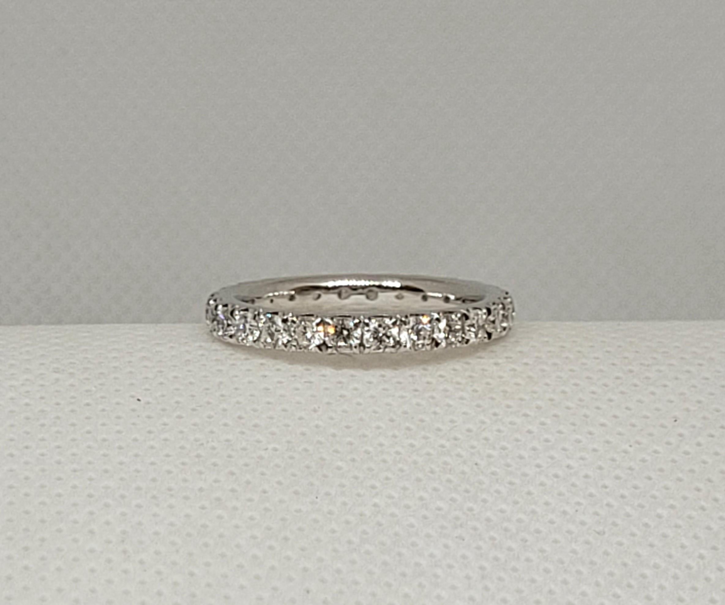 Gorgeous 14kt white gold eternity ring with 26 round brilliant diamonds of approximately .88cttw. The prong set diamonds are F/G in color, SI/VS in clarity, and well cut. The ring is 2.73mm wide, comfort-fit inside, 3 grams, size 6.5, and in very