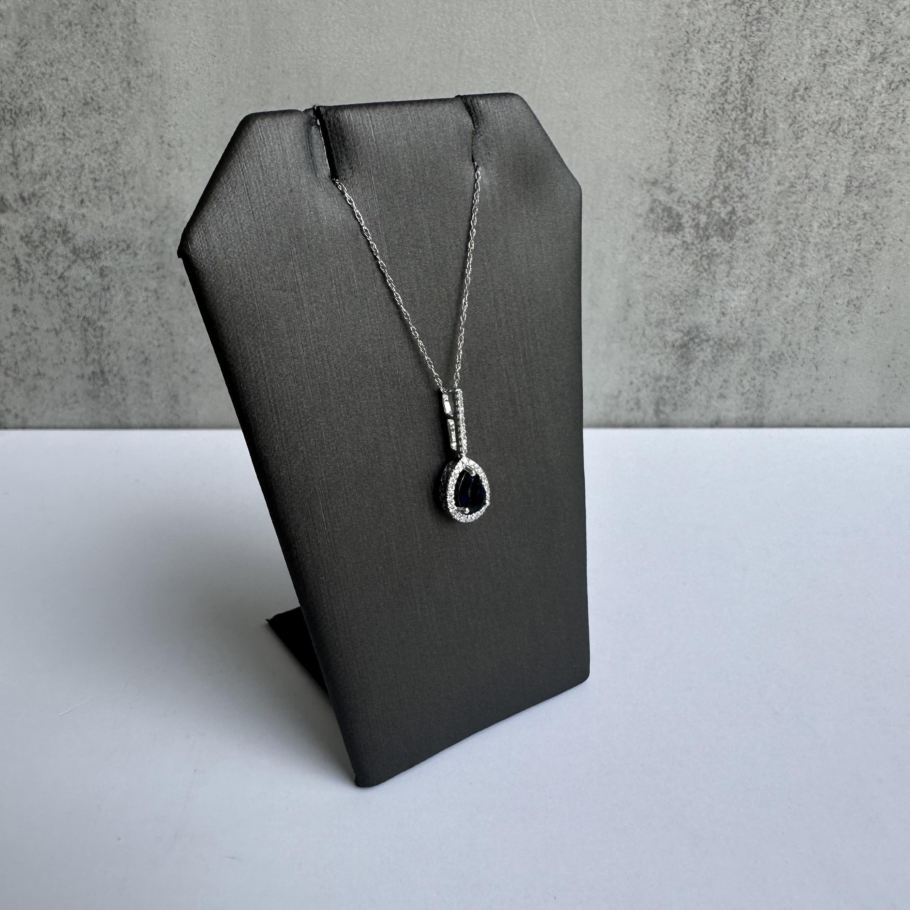 Enhance your jewelry collection with this exquisite 14kt White Gold Sapphire and Diamond Necklace. Featuring a 0.56ctw blue pear-shaped sapphire and 0.08ctw GH SI natural round single cut diamonds, this necklace combines timeless beauty with modern