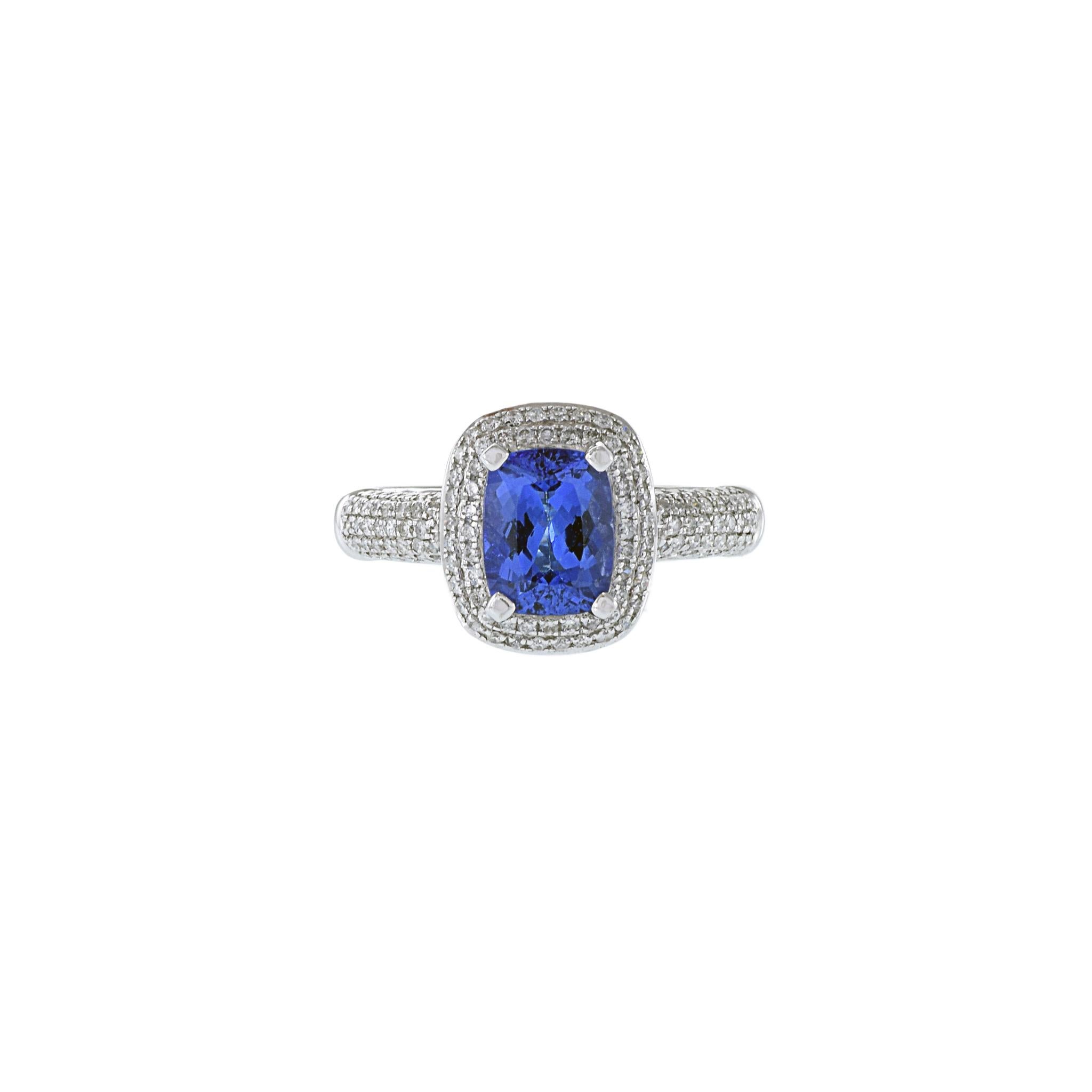 This exquisite ring is meticulously crafted from precious 14KT white gold, featuring a stunning 1.36CT tanzanite as its center stone. Complemented by a surrounding double halo of 0.54CT-TW F-G color, SI1-I1 clarity round-cut diamonds, this piece is
