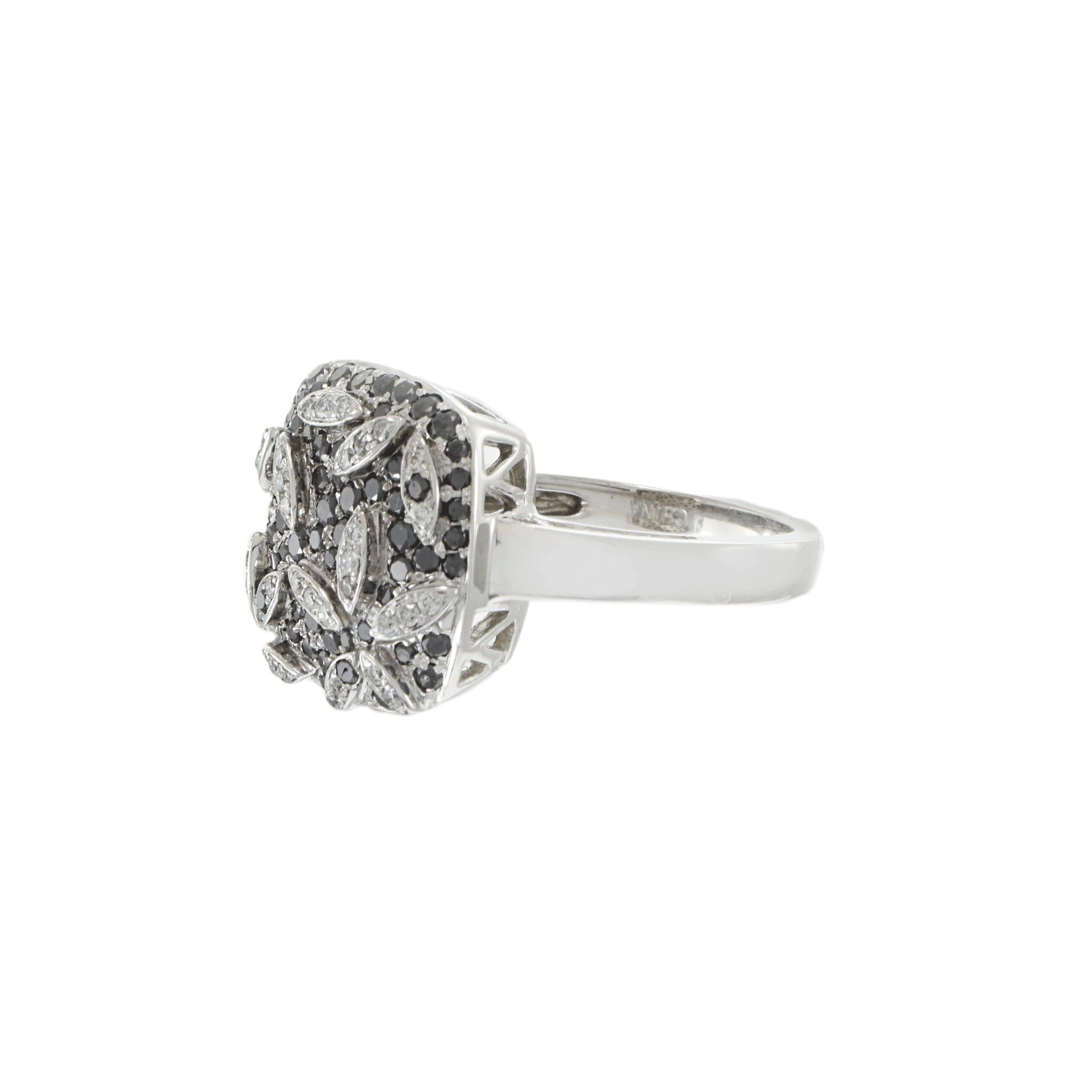 Elegant 14k White Gold Diamond and Black Diamond Ring. This exquisite ring is crafted in 14k white gold. The top features a stunning array of round black diamonds, interspersed with white diamonds in a captivating pattern. The intricate design