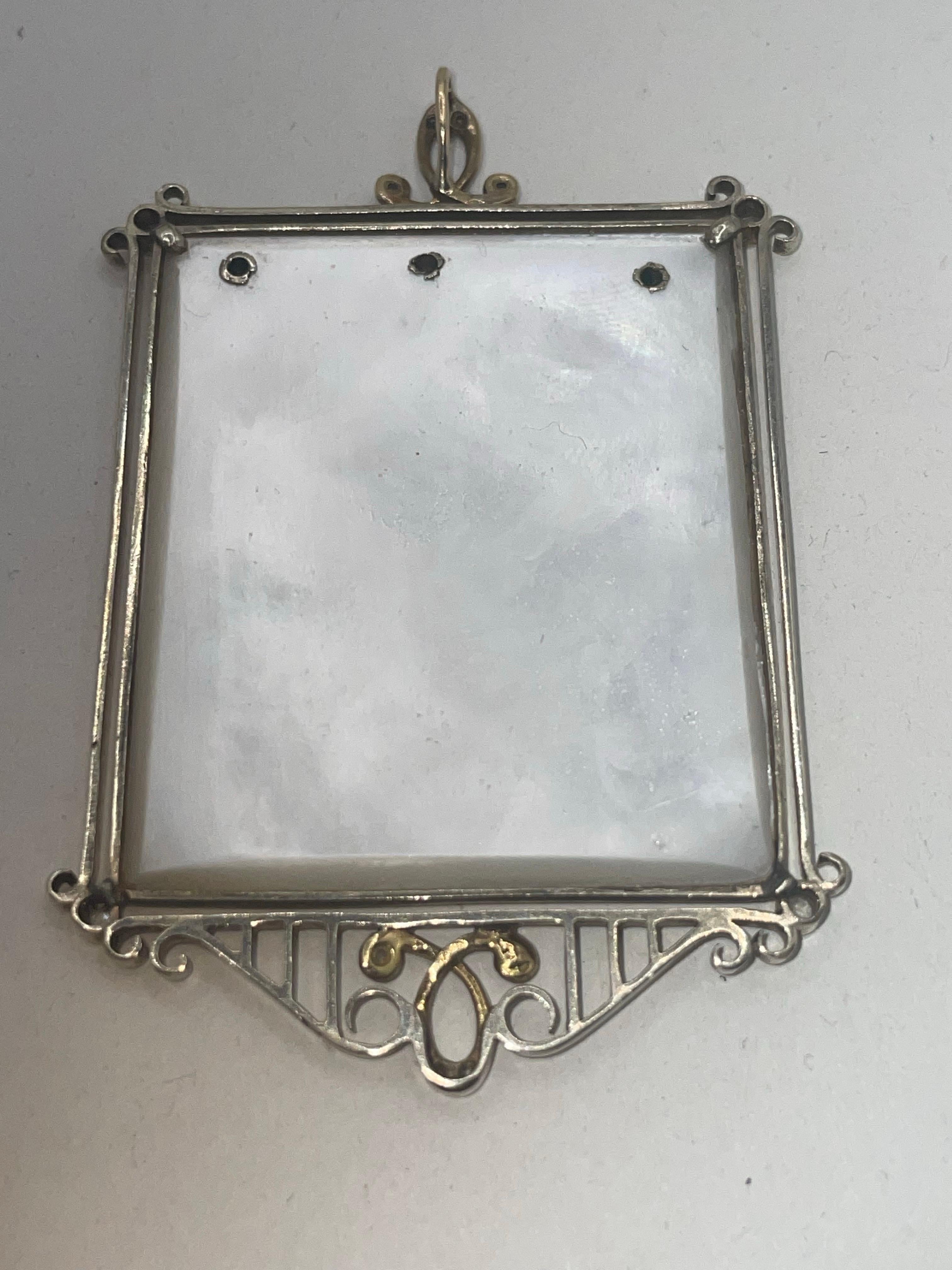 This Mother Mary pendant is made of white shining mother of pearl shell, 14 karat yellow and white gold as well as 15 mine cut diamonds. . none are missing. 
It is in original condition in excellent shape and condition. She has a halo around her
