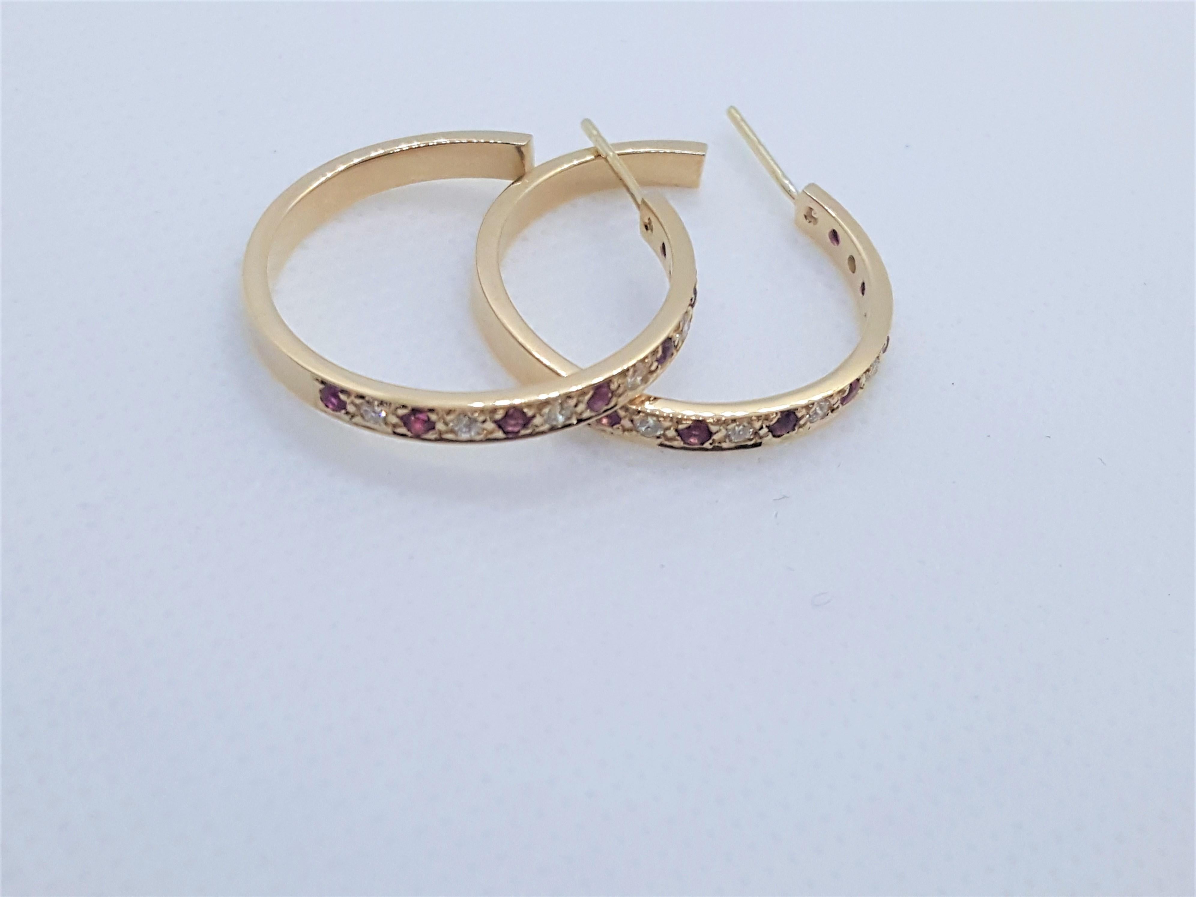 Timeless 14kt yellow gold hoops with 14 bead set round brilliant diamonds of approximately .15cttw and 14 round fine rich rubies of approximately .20cttw. The diamonds are g/h in color and SI in clarity. The hoops are 25mm in diameter, 3mm wide, 6.3