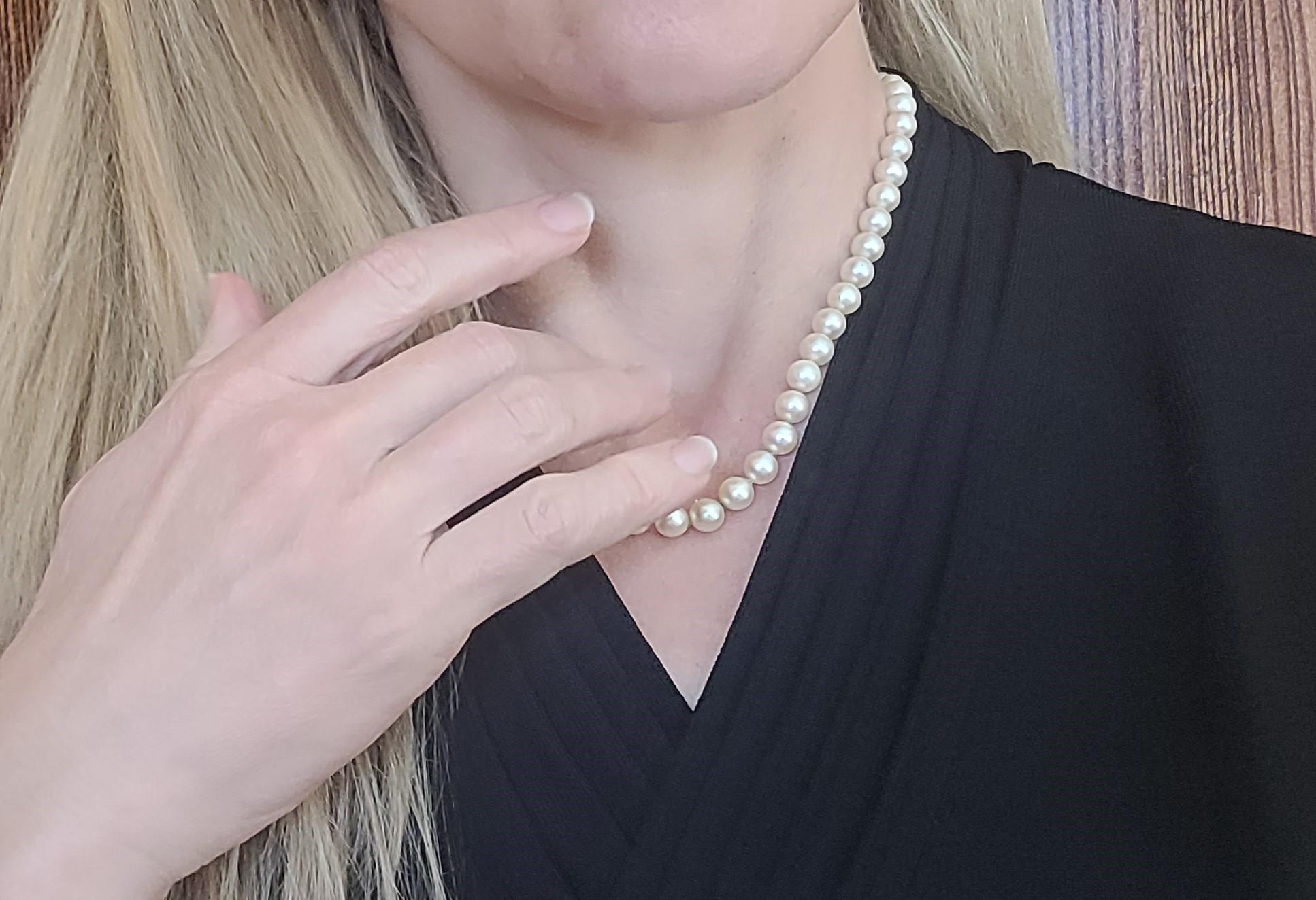 14kt Yellow Gold 18-inch Strand of 7mm Golden Cream Pearls, Knotted with Fish Clasp. This 18-inch knotted pearl strand features 7mm golden cream pearls secured with a fish-style clasp, which is stamped 14kt. Please note that the clasp has a slight