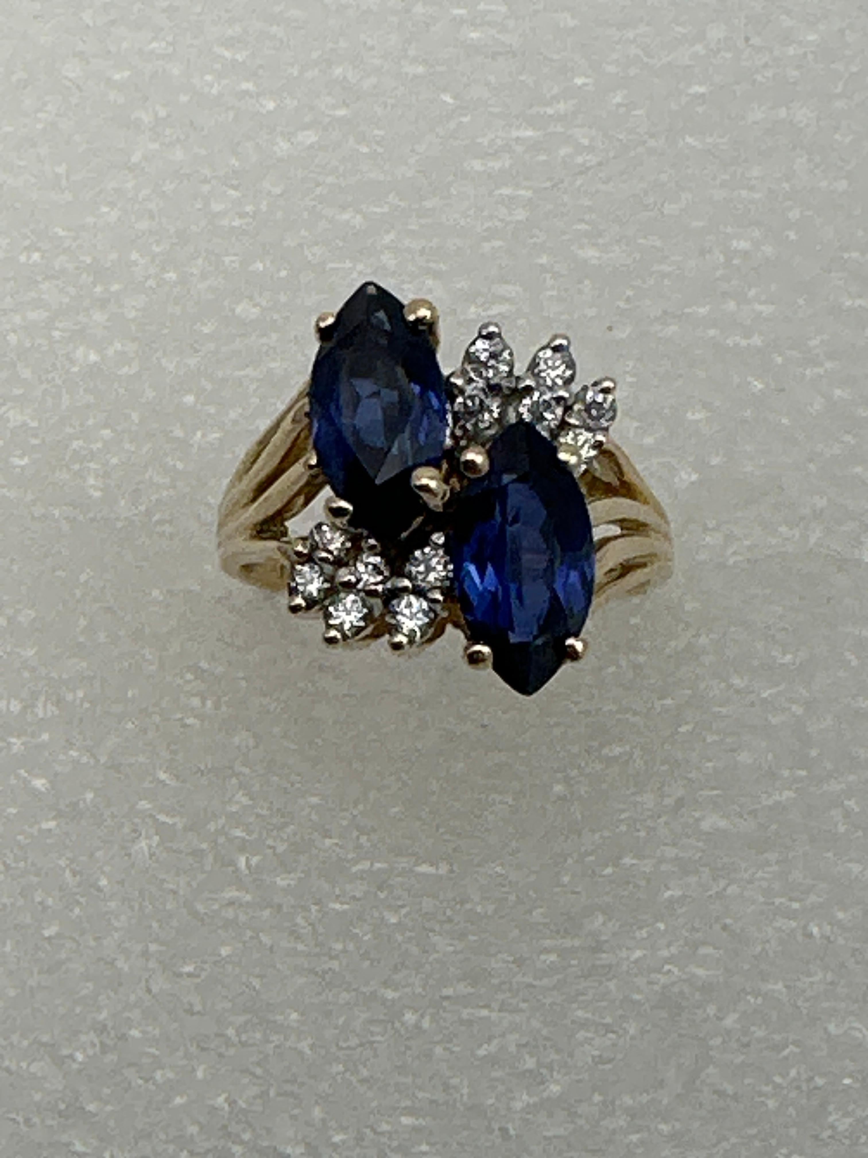 14kt Yellow Gold ~ 2 Sapphire Blue Marquise Stones 12 round Diamond Ring Size 6 1/2
Marquise sapphires measure approx 5mm x 10mm absolutely beautiful stones 
12 round Diamonds measure approx 2mm

Sapphire is the birthstone for the month of September