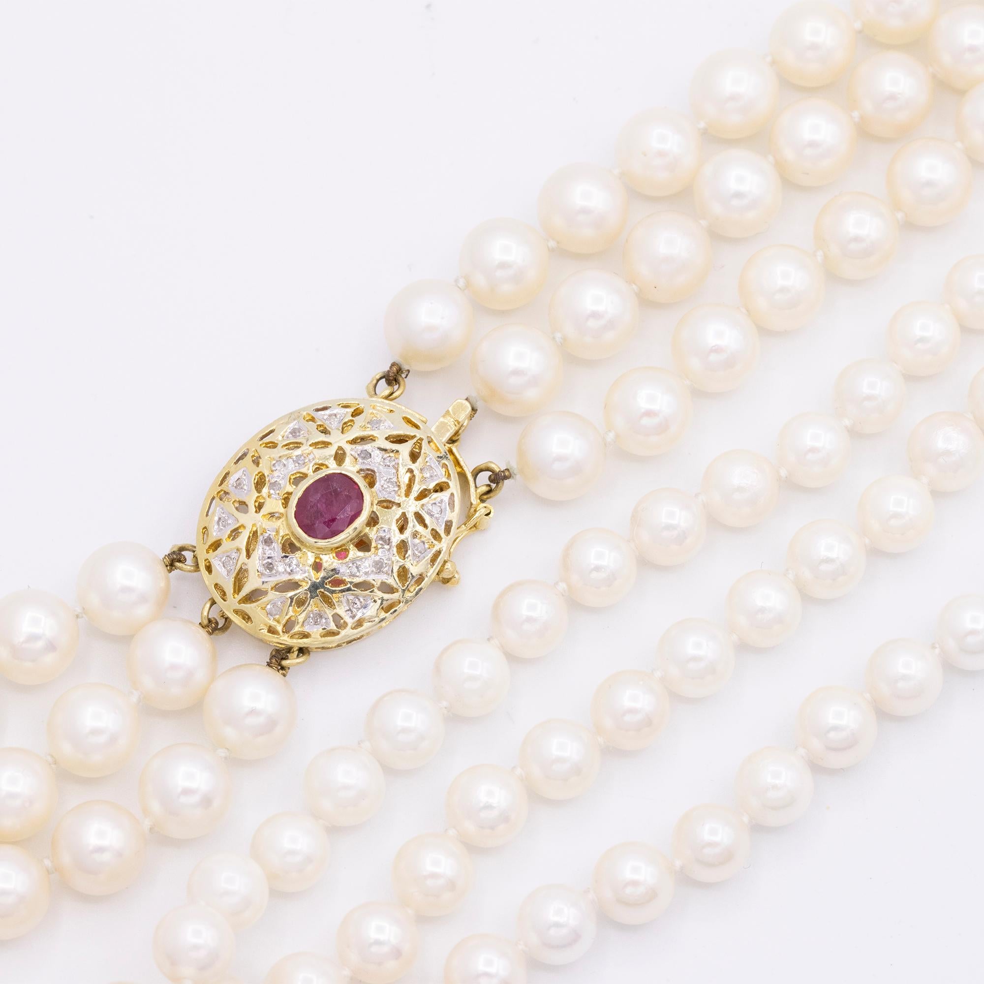 Vintage 14kt Yellow Gold 3 Strand Cultured Akoya Pearl Necklace. It has one oval shaped Ruby & Diamonds on the clasp. It has 168 Cultured Akoya pearls. This necklace is 16