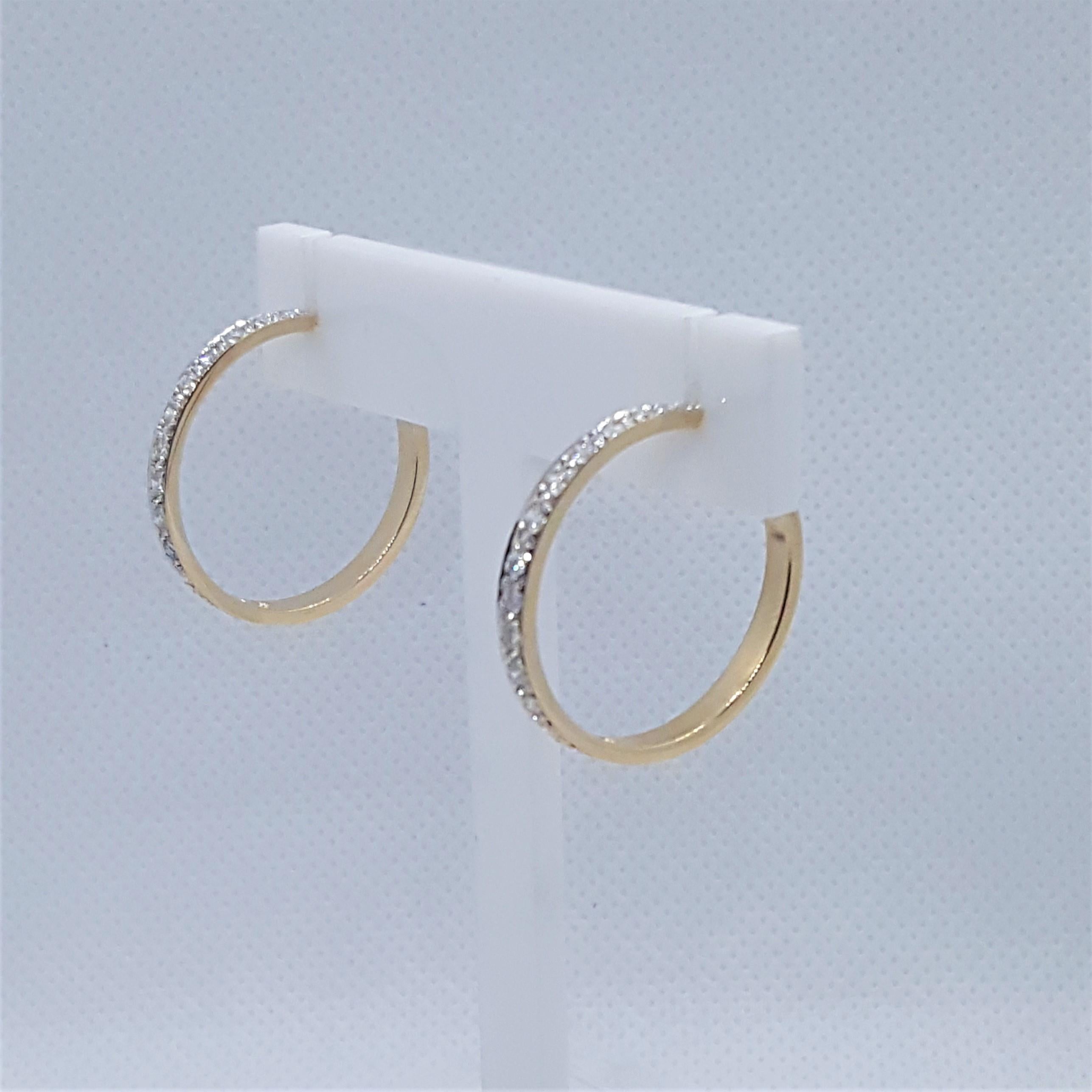 Timeless 14kt yellow gold friction post hoop earrings with 28 bead round brilliant diamonds that are g/h in color, SI in clarity, and approximately .30cttw. The hoops are 25mm in diameter and 3mm wide, weighing 6.2 grams.  The estimated time period