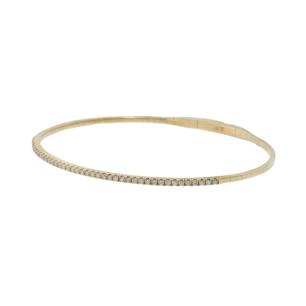Crafted in luminous 14KT yellow gold, this stunning flex bangle is adorned with a delicate row of round brilliant diamonds totaling 0.50 carats. Its flexible construction ensures ease of wear and a sleek silhouette, making it a timeless addition to