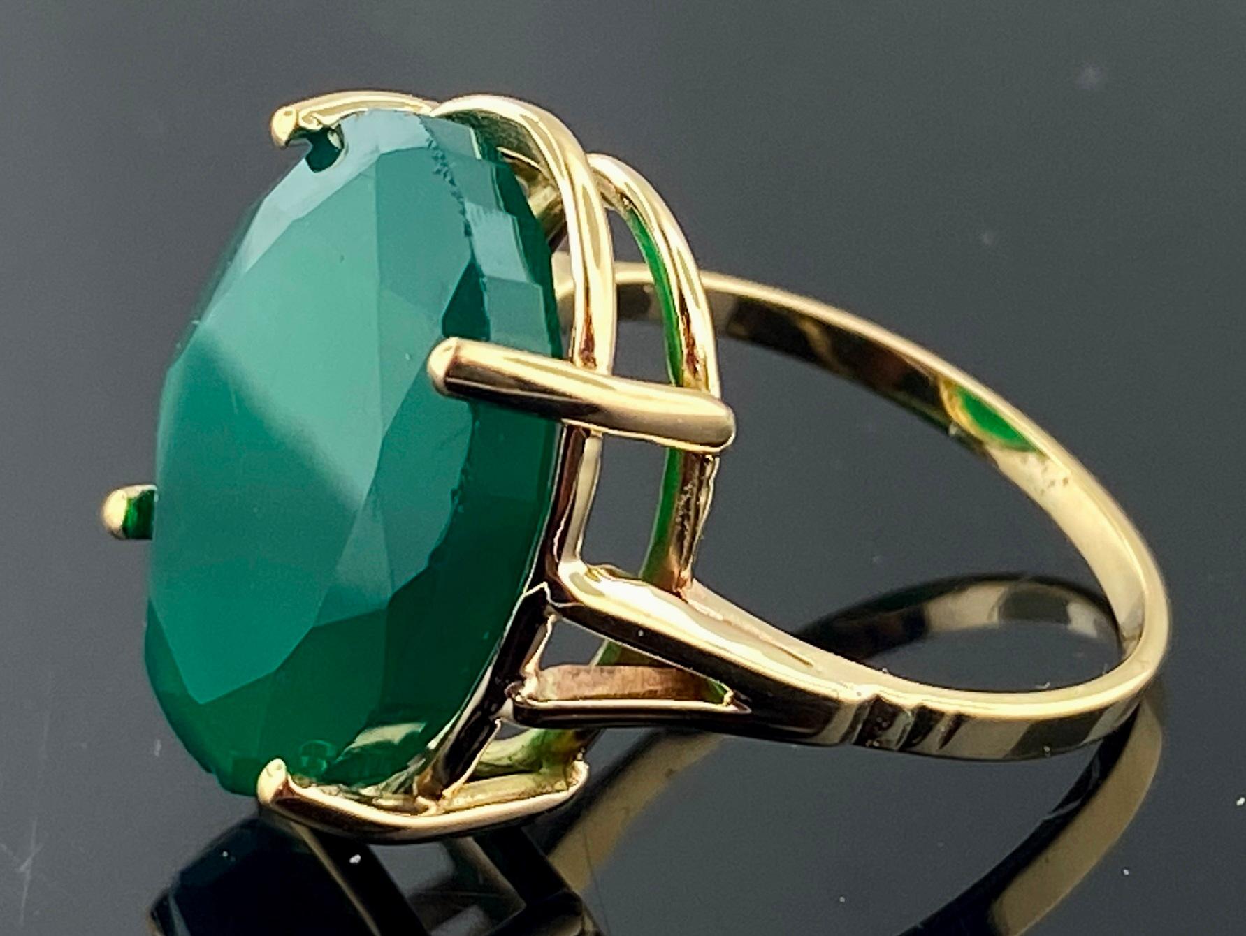 Set in 14 karat yellow gold is a green Oval Chalcedony stone weighing 9.33 carats.  Ring size is 6,