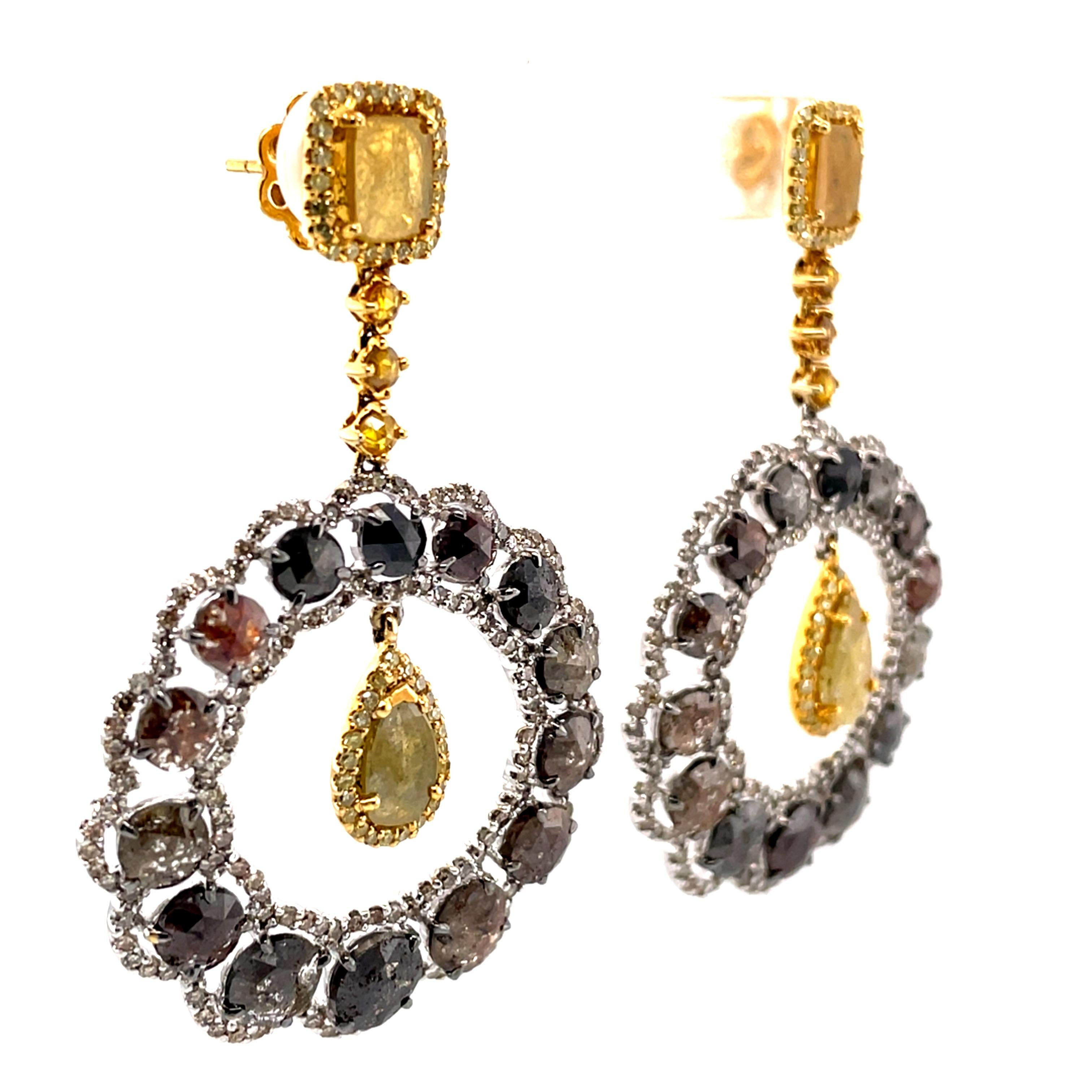A beautiful pair of 14Kt yellow and white gold chandelier earrings featuring 1.73 carats of yellow fancy shaped rose cut diamonds, 7.30 carats of fancy brown round rose cut diamonds and 2.40 carats of round brilliant cut diamonds. Some of the fancy