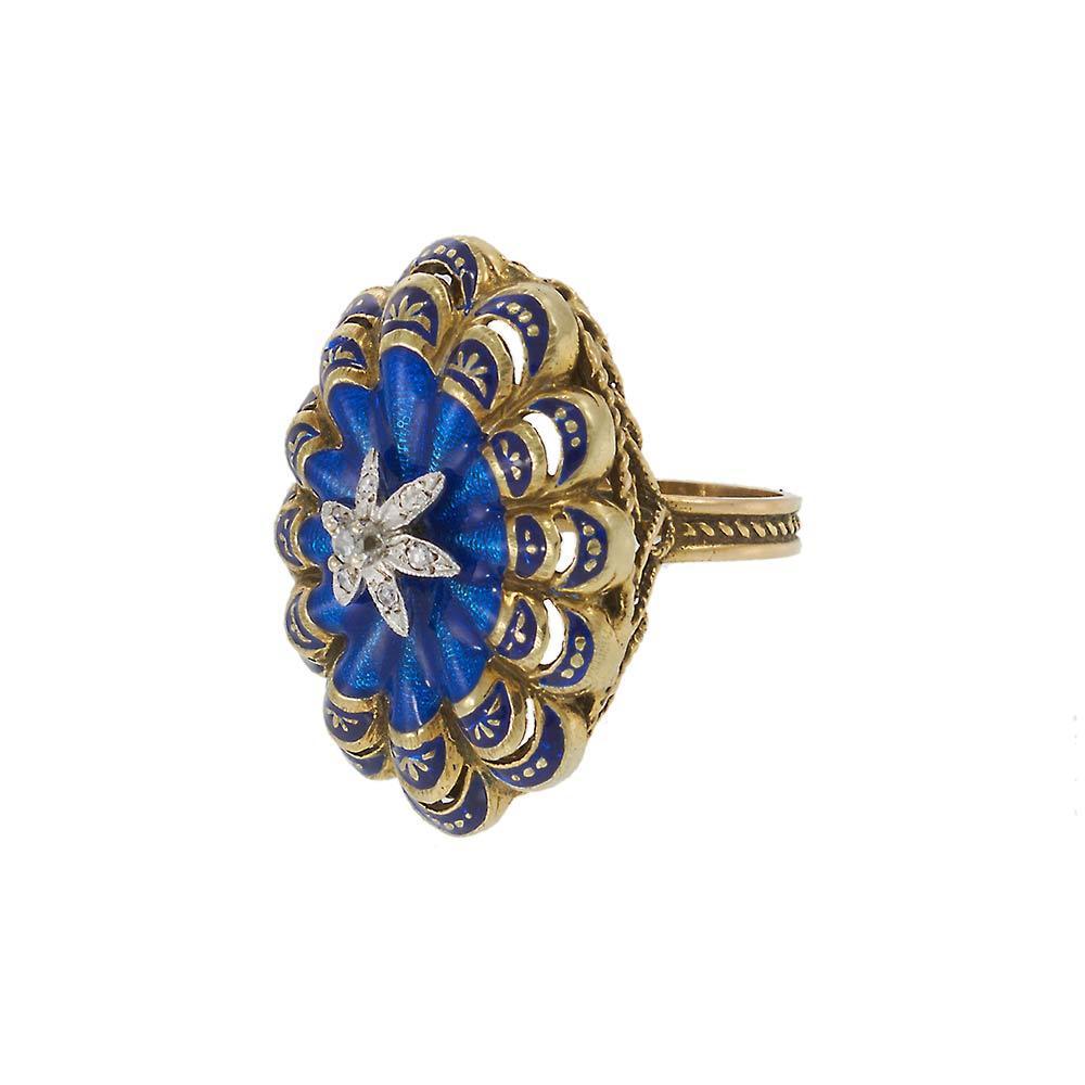 A stunning piece of history, this Antique Victorian-era ring is crafted in 14KT yellow gold and adorned with vibrant blue enamel work. A sparkling diamond-set star sits at the center, adding a celestial touch to its intricate design. The detailed