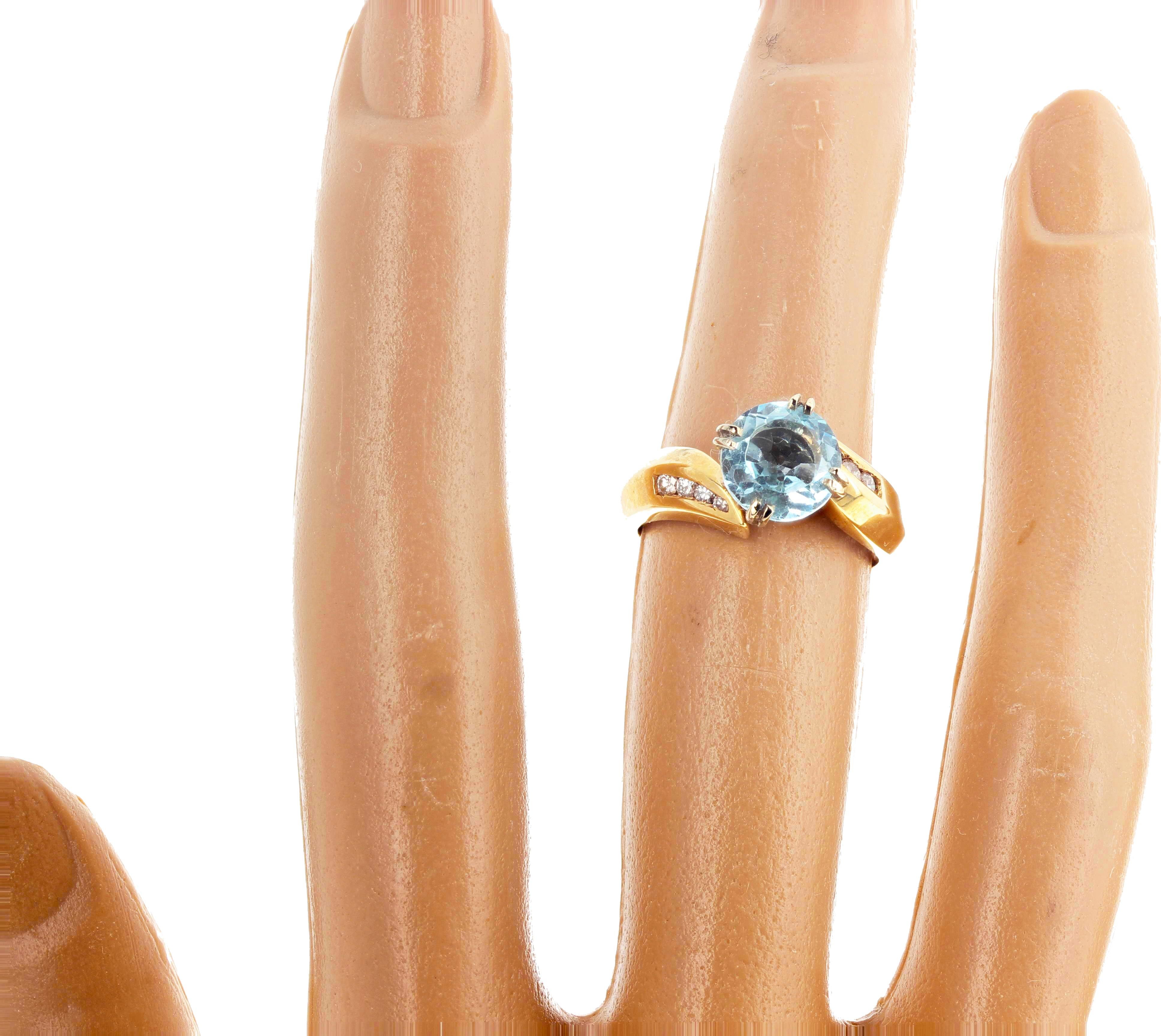 This delightful round gem cut bright blue Aquamarine - 1.68 carats - 8 mm - no eye visible inclusions - enhanced with little sparkling real white Diamonds set in this lovely 14Kt yellow gold ring size 6.5 sizable FOR FREE.  This is perfect for