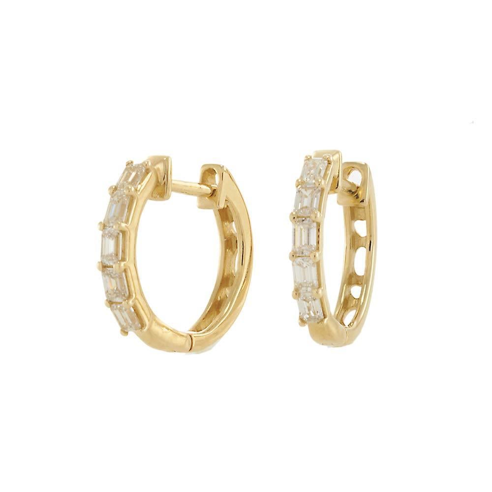 Clean lines and bold brilliance define these 14KT yellow gold huggie hoop earrings, set with sleek baguette-cut diamonds totaling approximately 1.64 carats. Each stone is secured in a channel-style setting that enhances the diamonds’ step-cut