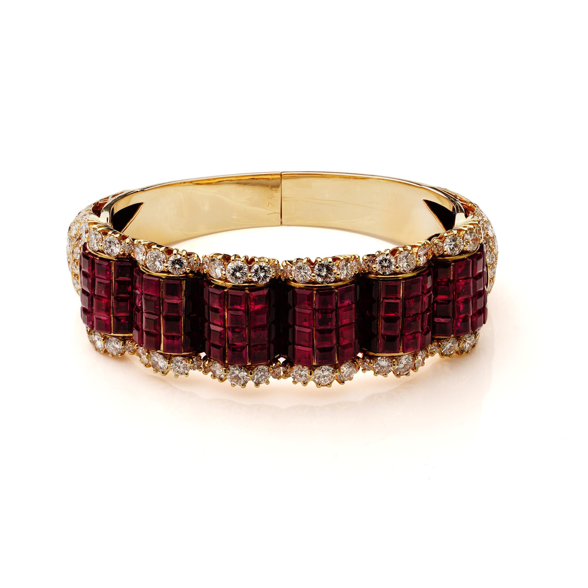 14kt. yellow gold bangle set with 18 ct. rubies and  12.84 ct. diamonds.

Dimensions:
Inner diameter - 5.4 cm, Width - 2.1 cm
Weight: 81 grams

Rubies -
Cut: Square
Quantity of Rubies: 120
Each Individual Size: 0.15 ct. 
Approx. total weight: 18 ct.