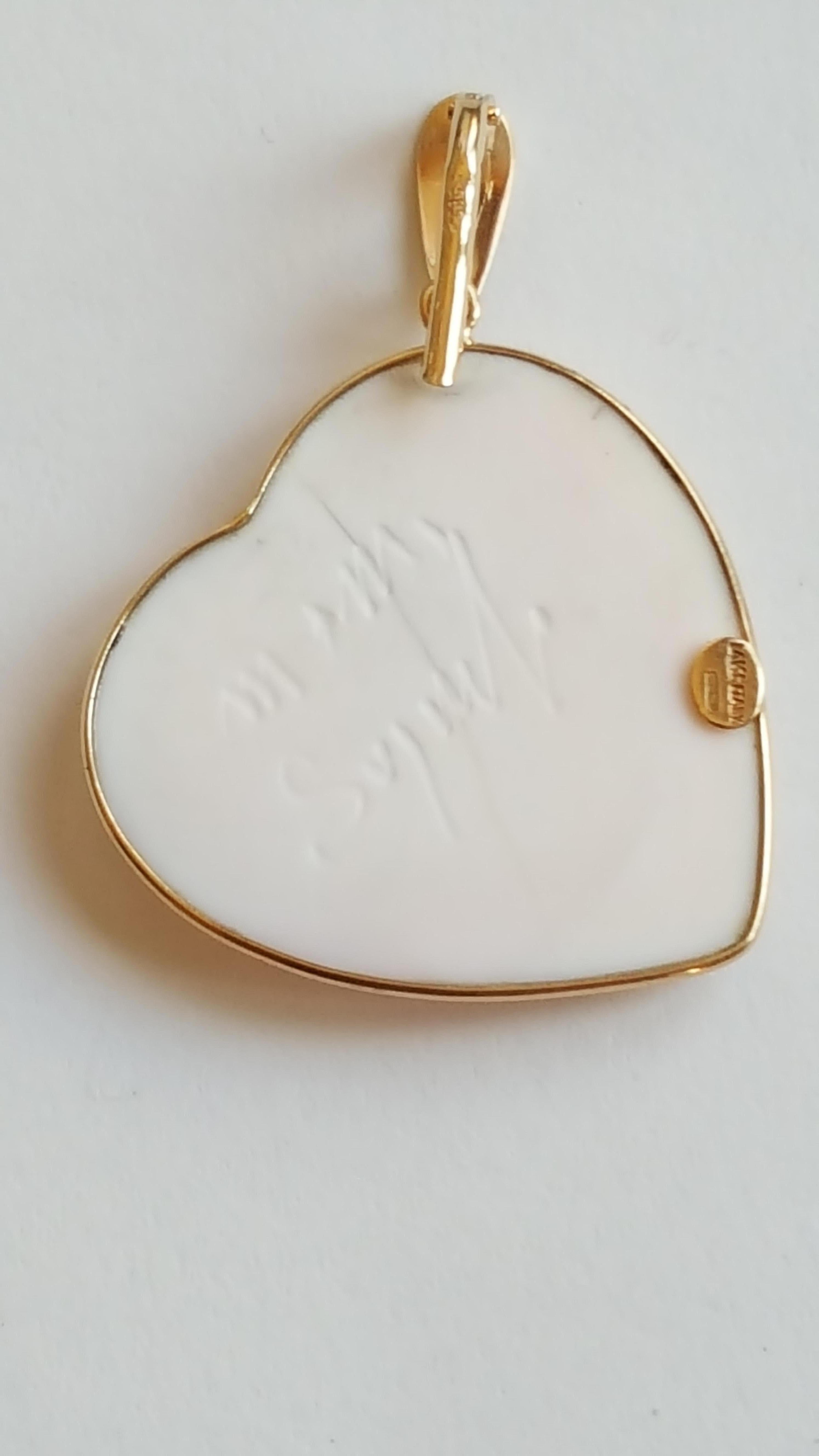 14kt Yellow Gold Bezel Heart  Pink Shell Cameo Pendant, Made by Italian Designer M + M Scognamiglio, Signed. Hallmark 14kt Yellow Italy, 585. Designer signature is etched on the back.
This Looks brand new, not worn, excellent condition. 

30mm by 30