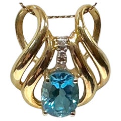 Ciondolo in oro giallo 14 carati con topazio blu e diamanti