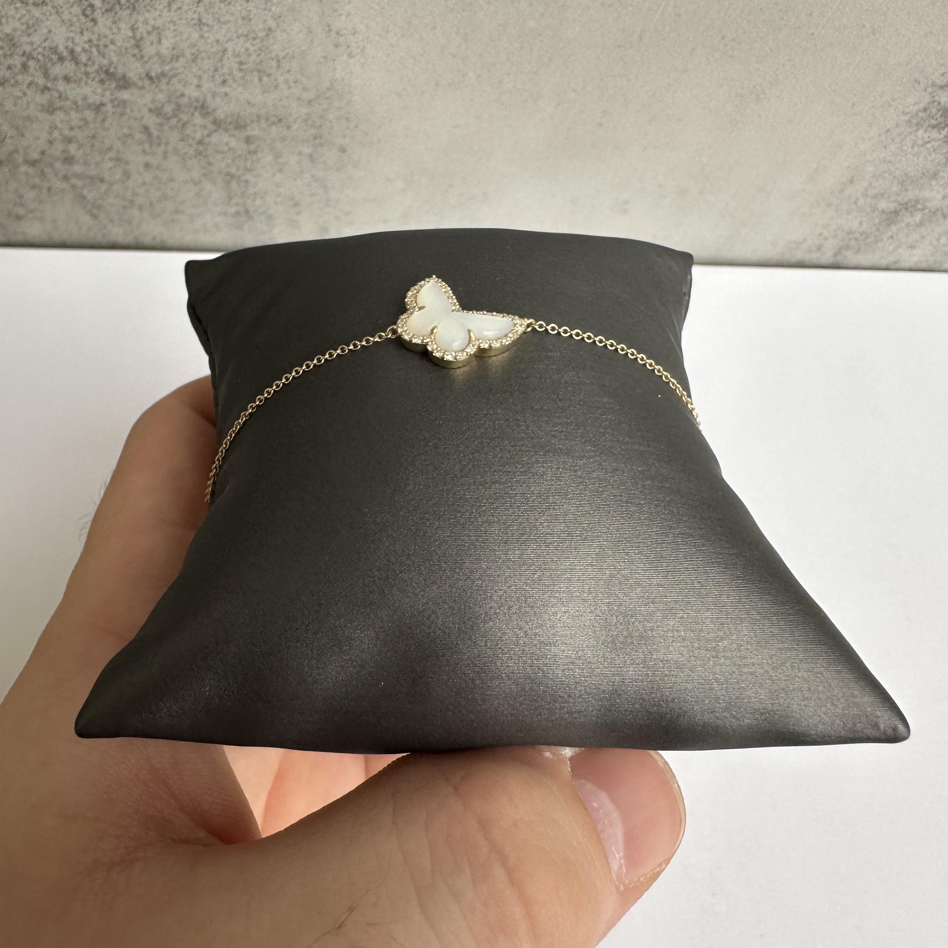 Embrace elegance with this charming 14kt Yellow Gold Butterfly Bracelet, featuring 0.20 carats of sparkling GH color, SI2 clarity natural diamonds and a delicate mother of pearl inlay. Designed with an adjustable length of 6 to 7 inches, this