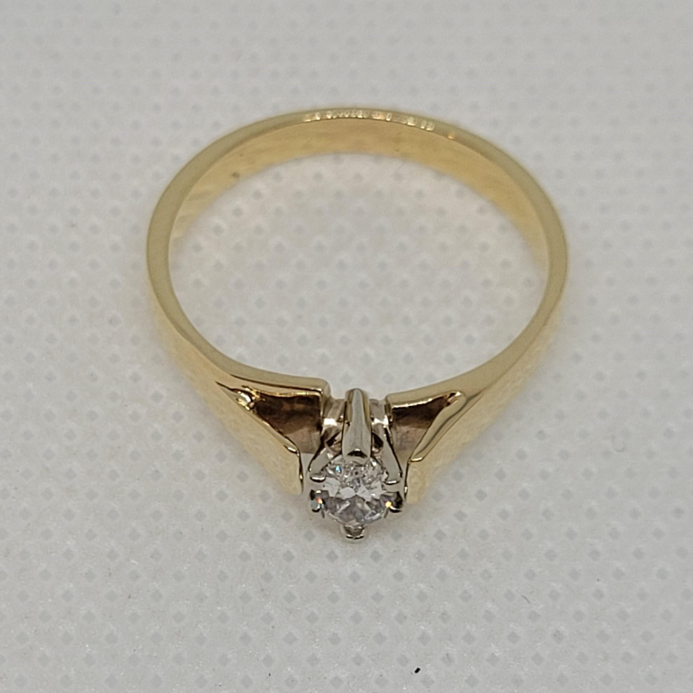 Classic 14kt yellow gold cathedral-style ring with a six prong 14kt white gold head holding a .25ct marquis cut diamond. The diamond is H in color and SI in clarity with a good cut. The ring weighs 3.1 grams, is 7.5 in size, and is 3mm tapering to