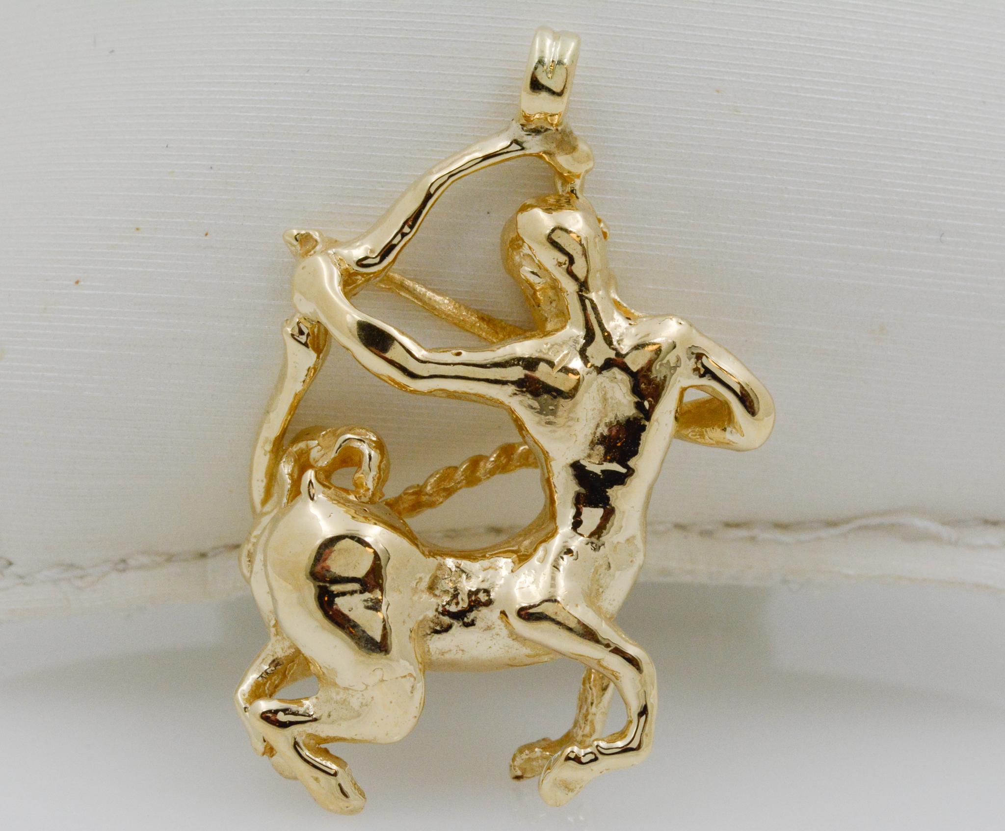 This 14k yellow gold charm features a centaur design, holding a bow and arrow. A centaur is a mythical creature with the torso of a man, and the lower body of a horse, complete with hooves and a tail. Originating from Greek mythology, and much of