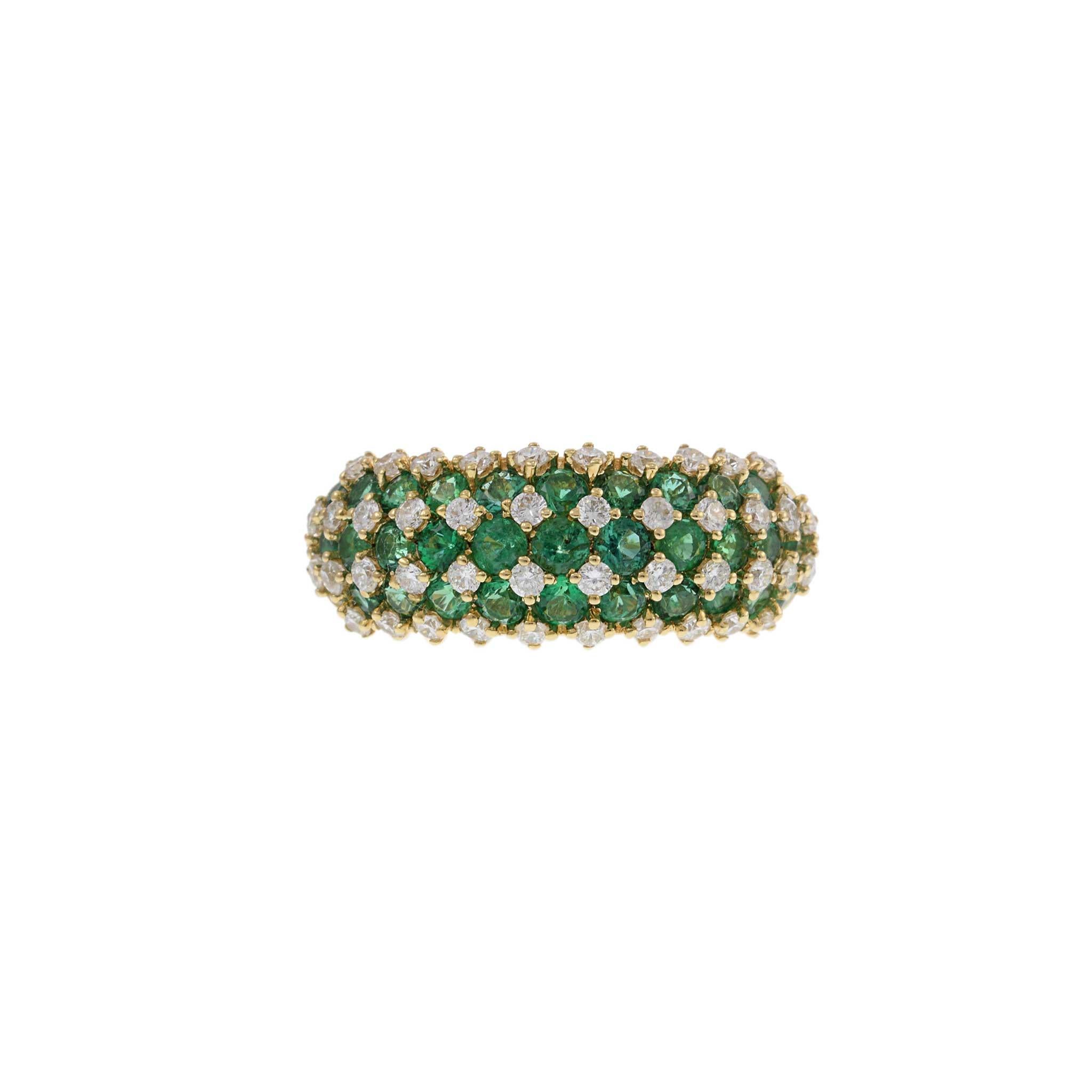 This striking dome ring features a checkerboard pattern of 1.51 carats of round cut emeralds and 0.64 carats of round cut diamonds, all set in 14KT yellow gold. The vibrant green emeralds and sparkling diamonds create a stunning visual effect,