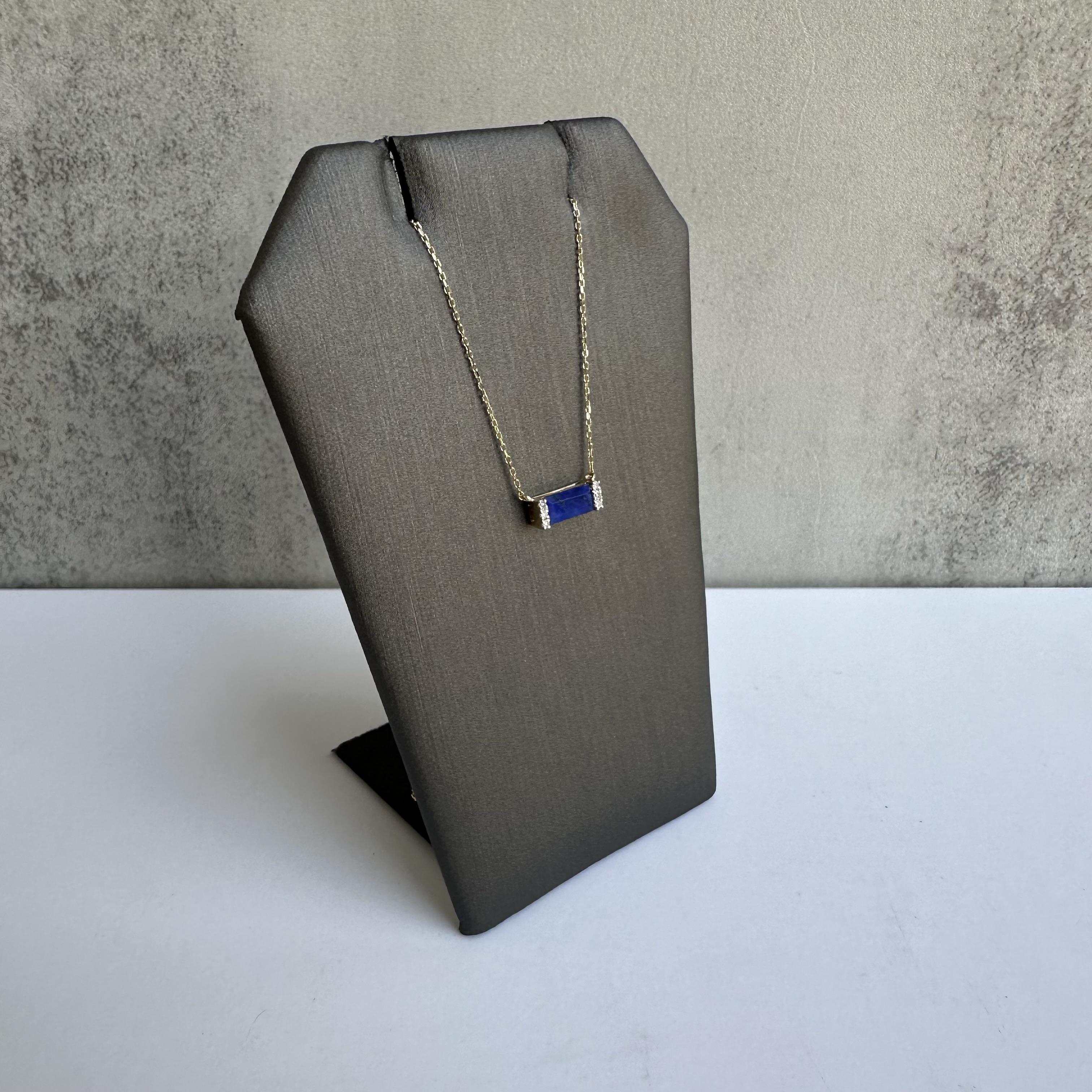 Add a touch of elegance and color to your collection with this Diamond and Lapis Necklace in 14kt Yellow Gold. Featuring 0.03 carats of GH I1 natural round single cut diamonds paired with a beautifully polished lapis lazuli stone, this necklace