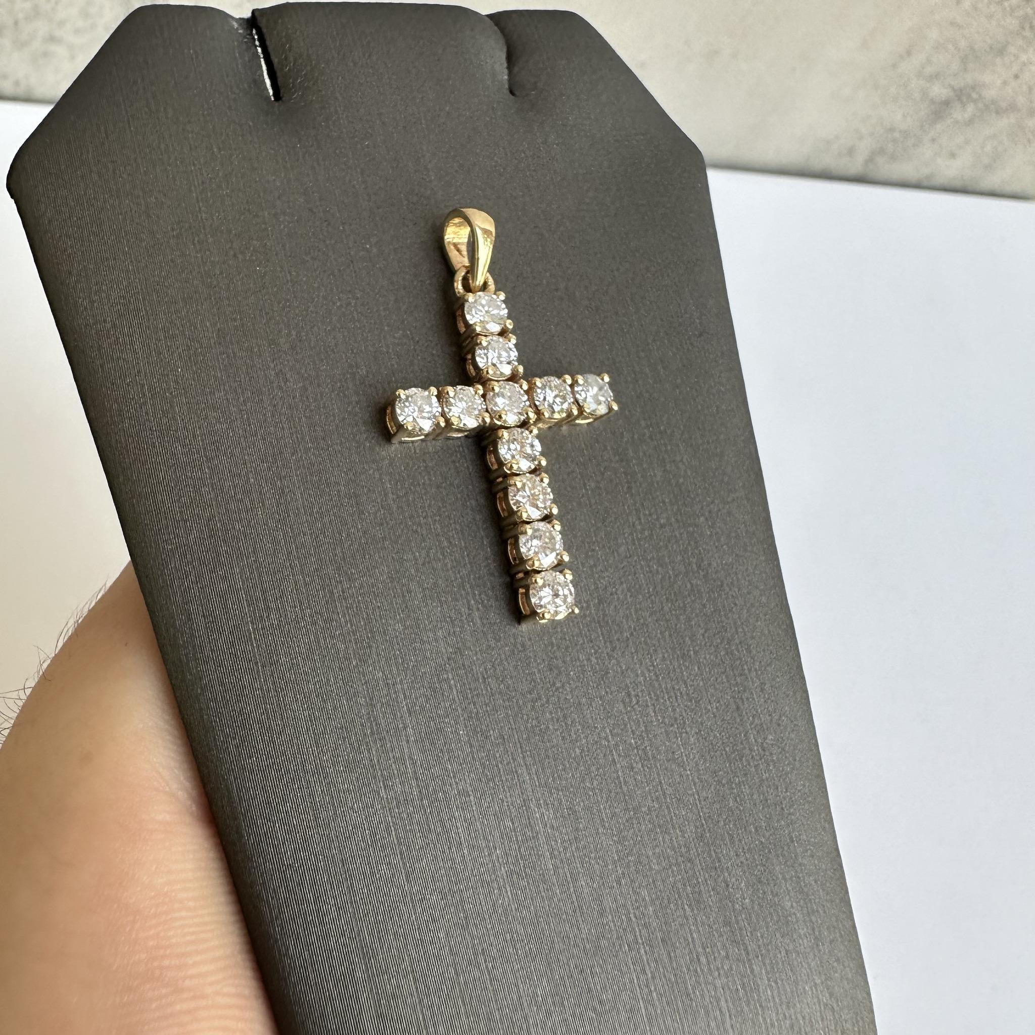 Elevate your jewelry collection with this stunning 14kt Yellow Gold Diamond Cross Pendant. Featuring a total of 1.75 carats of natural GH SI round diamonds, this pendant offers a brilliant sparkle that is both timeless and elegant. Crafted in