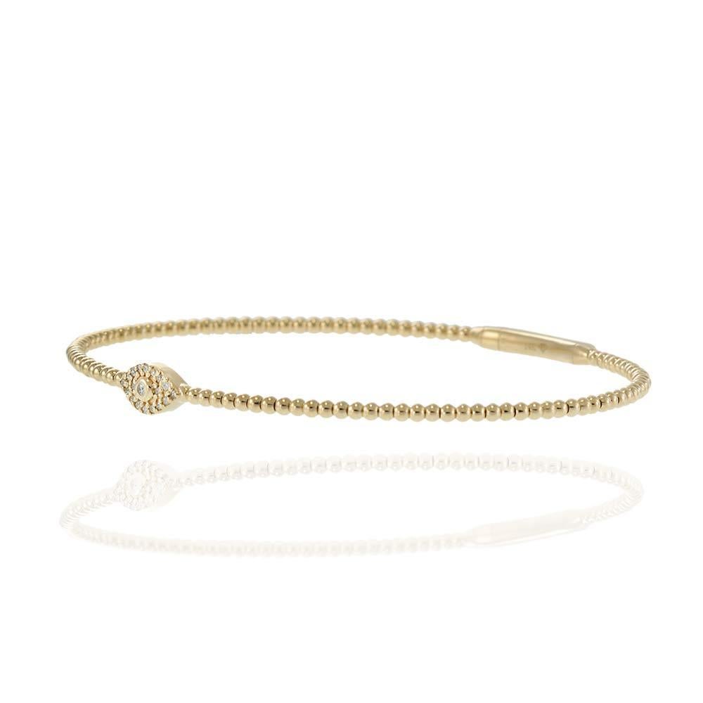 This sleek and symbolic flex bangle is crafted in 14 karat yellow gold and features a beaded design accented by a sparkling pavé diamond 'Evil Eye' centerpiece. Believed to offer protection and ward off negative energy, the Evil Eye motif is adorned