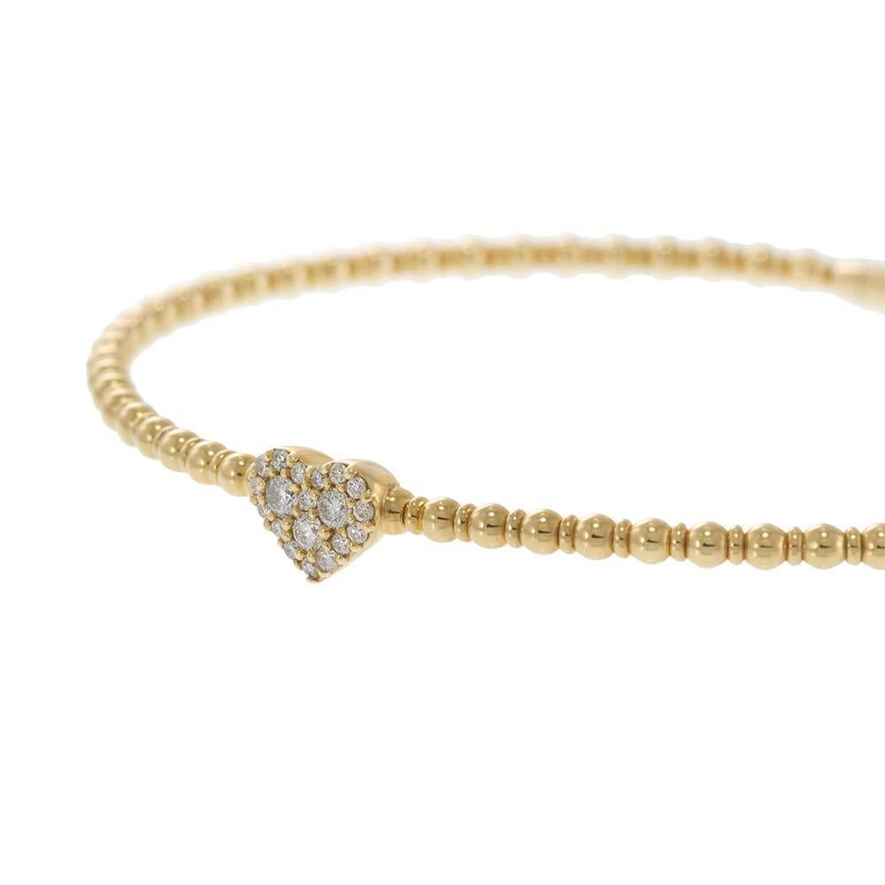 A sweet statement of affection, this 14KT yellow gold beaded flex bangle features a pavé-set diamond heart at its center, beautifully contrasted by the warm tone of polished gold beads. With 0.18 carats of sparkling diamonds, this flexible bangle