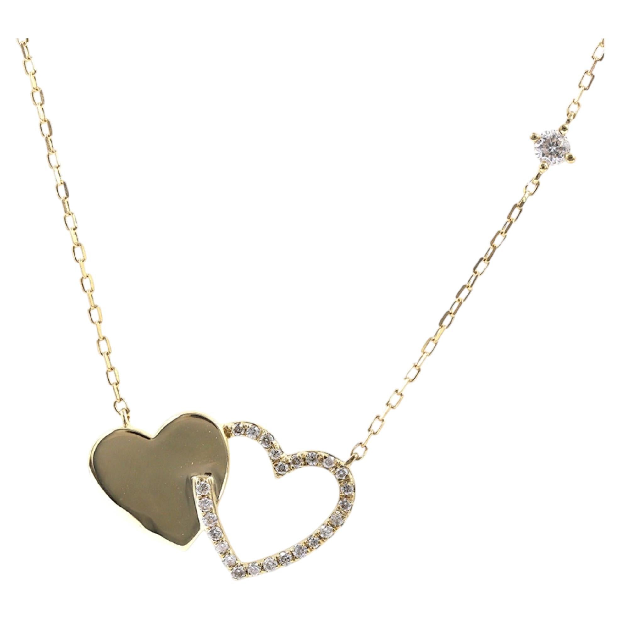 Collana con doppio ciondolo a cuore intrecciato in oro giallo 14KT con diamanti